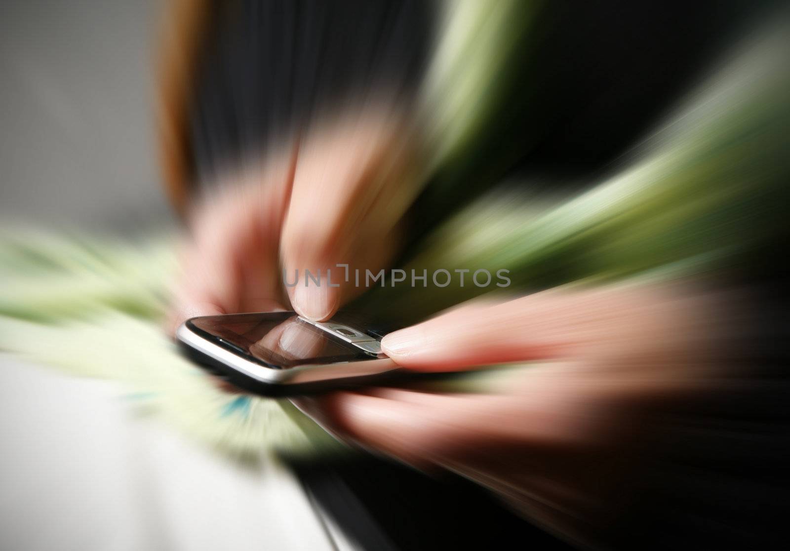 Senior  female, writing a text message - zoom blur.