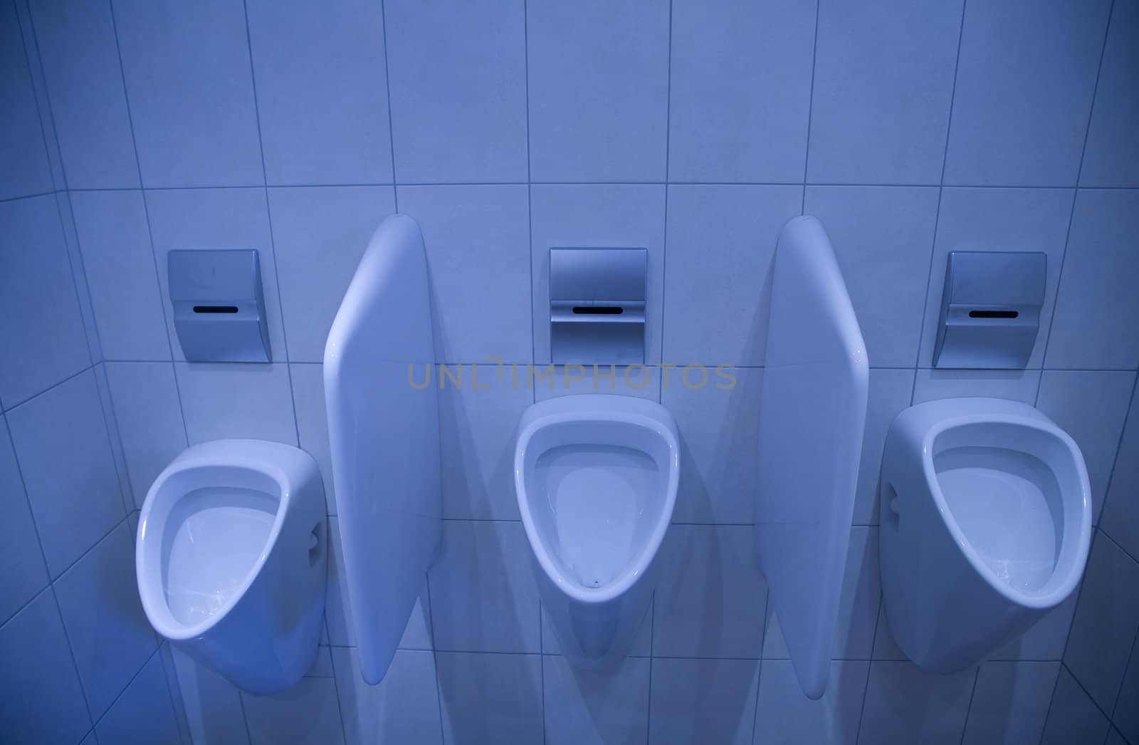 Three nice and clean urinals in a row.
