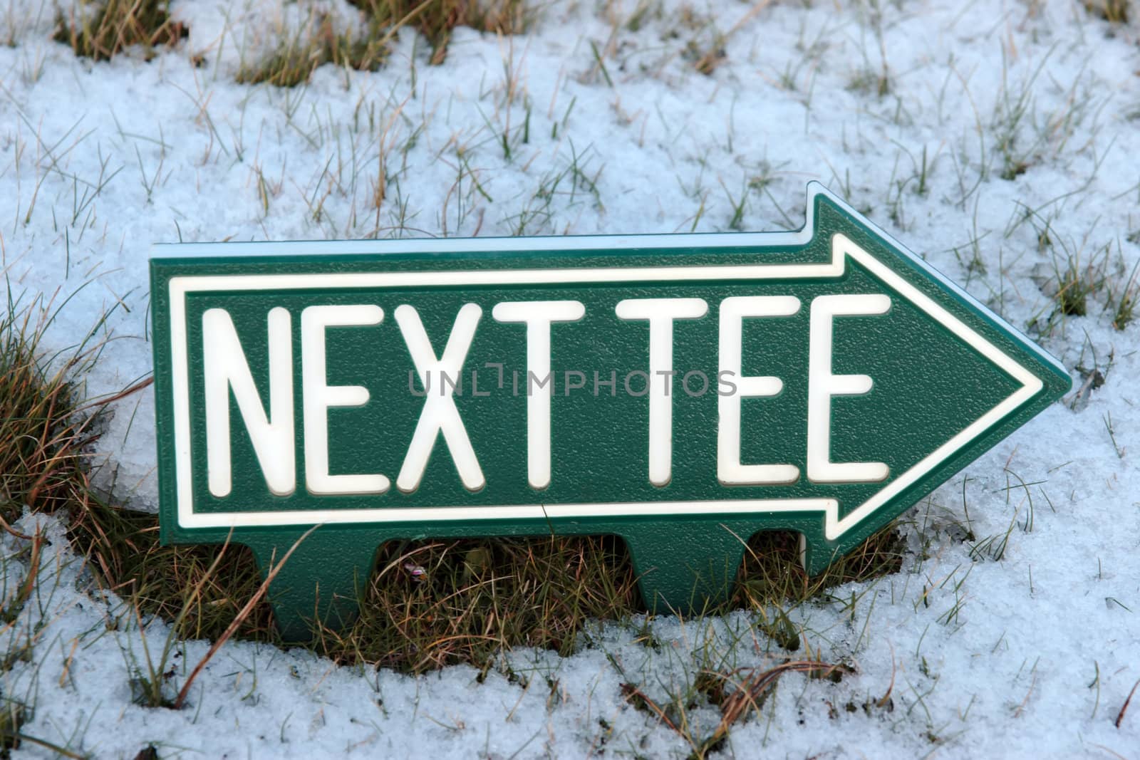 the next tee sign on an irish golf course in the winters snow