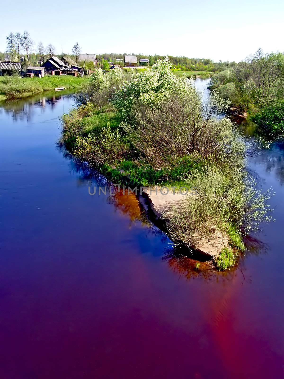 island on river near villages