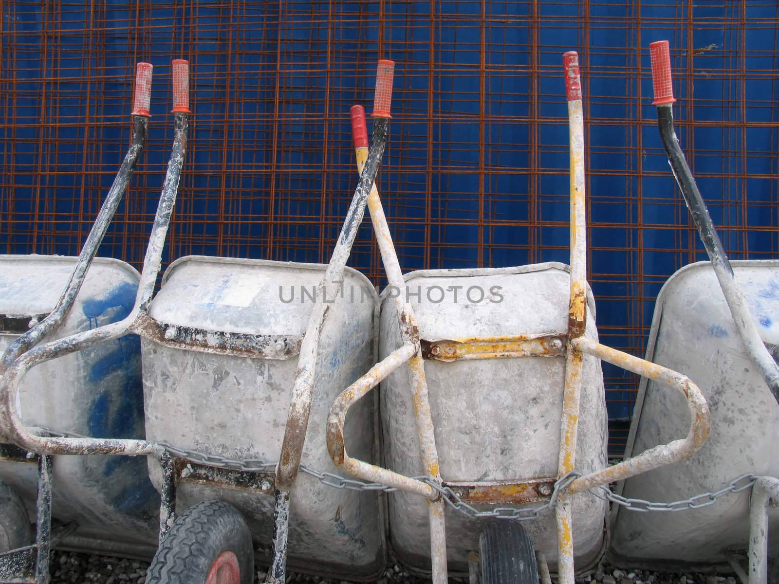 Parked and chained wheel barrows after work.