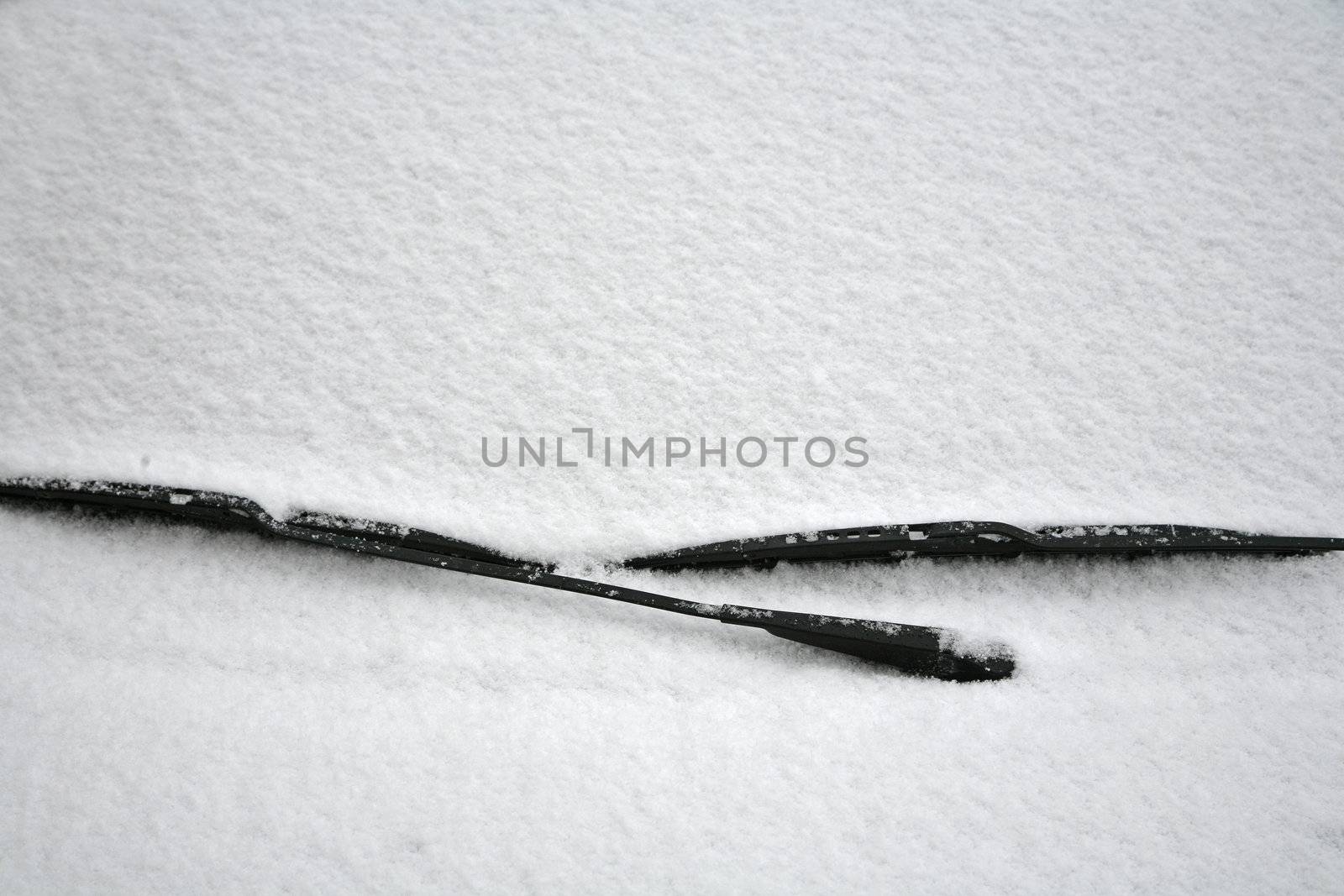 Windscreen wipers and a snow covered car.