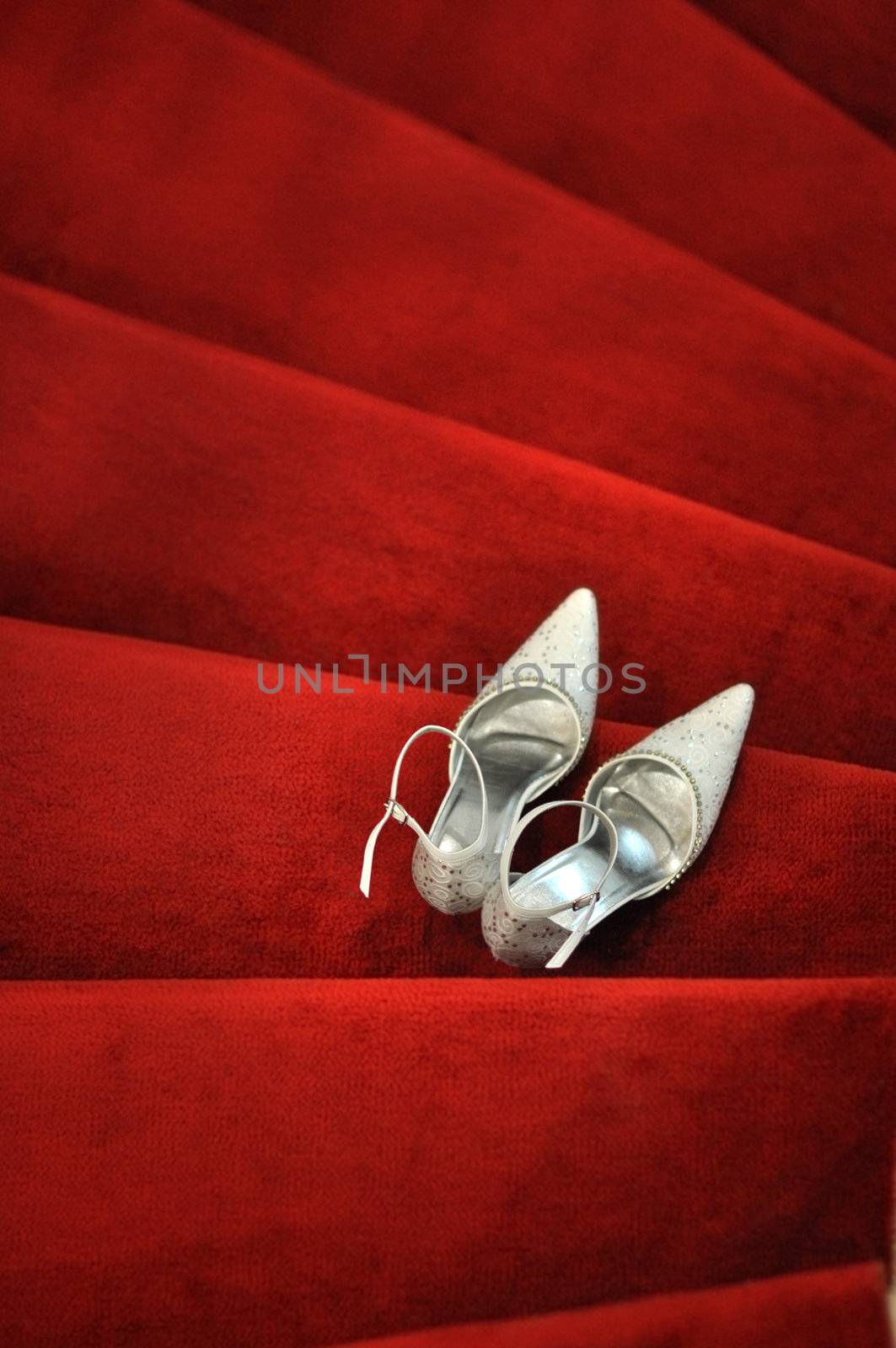 White bridal shoes on red carpet