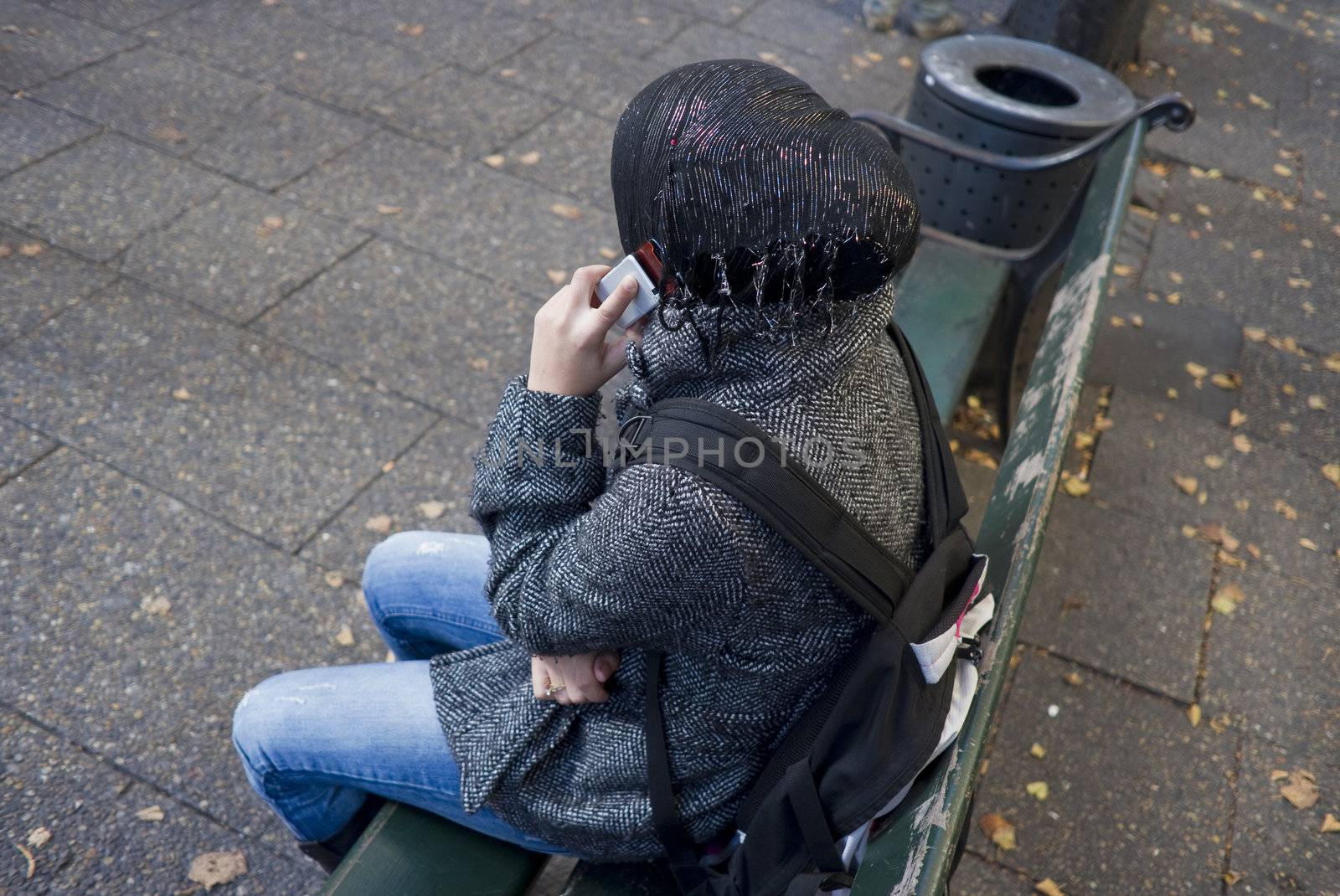 Young ethnic Danish girl wearing scarf and talking in mobile phone - Copenhagen, Denmark.