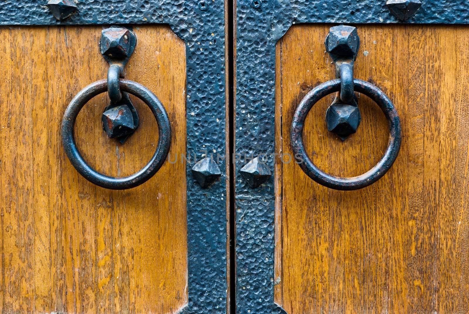 Closeup of wooden vintage door with metal door handle, old medival style taken in Moscow, Russia
