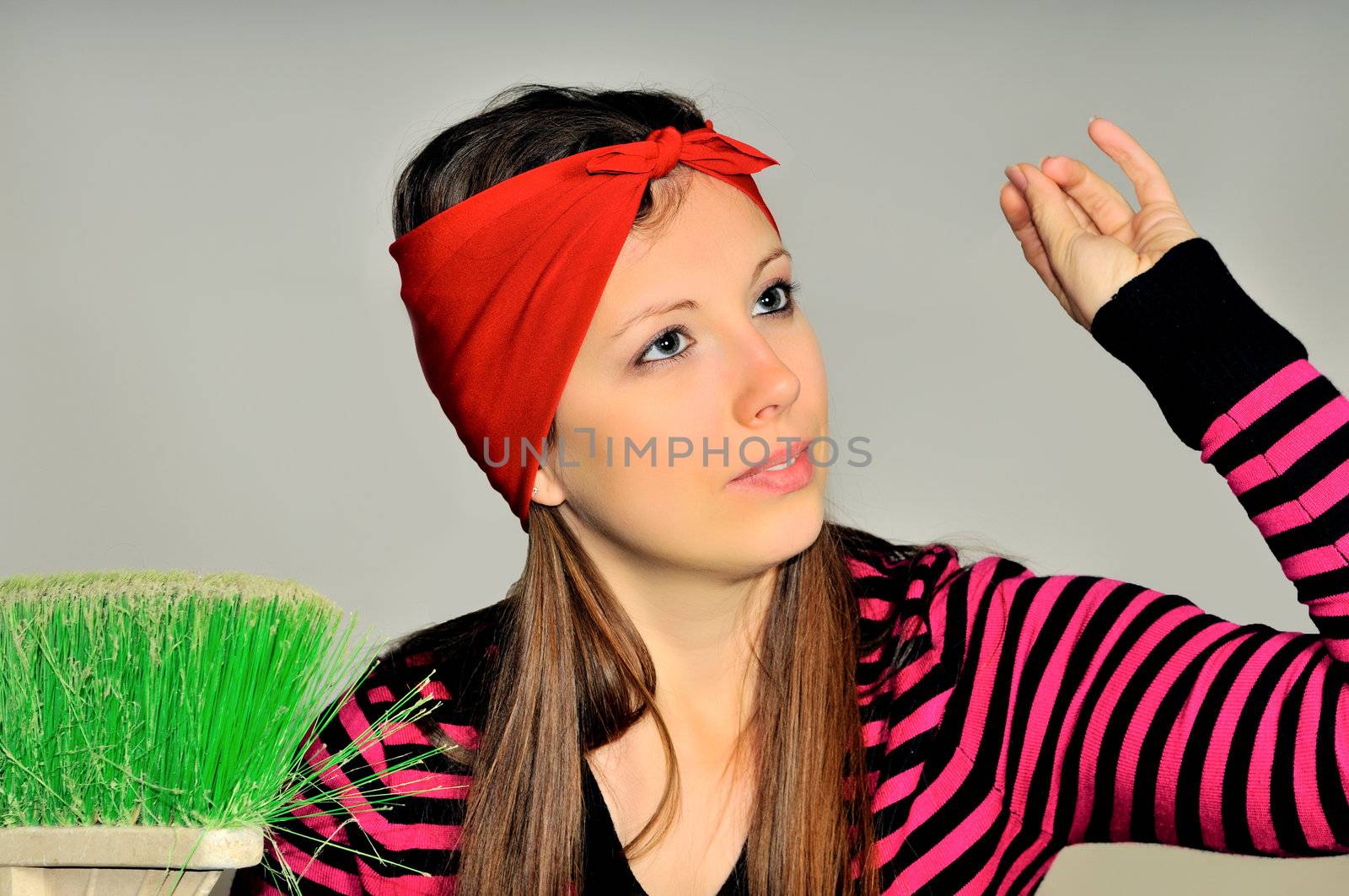 Girl with a red handkerchief on his head preparing to clean the apartment