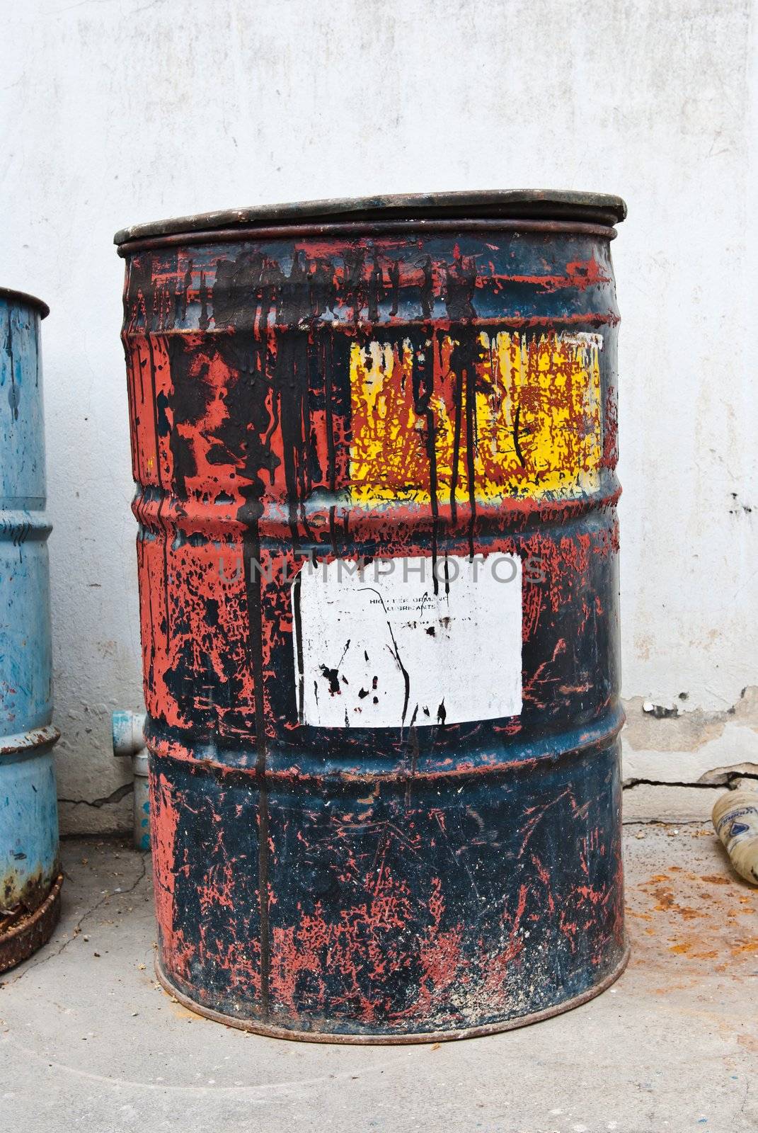 Old rusty oil drum with white sticker
