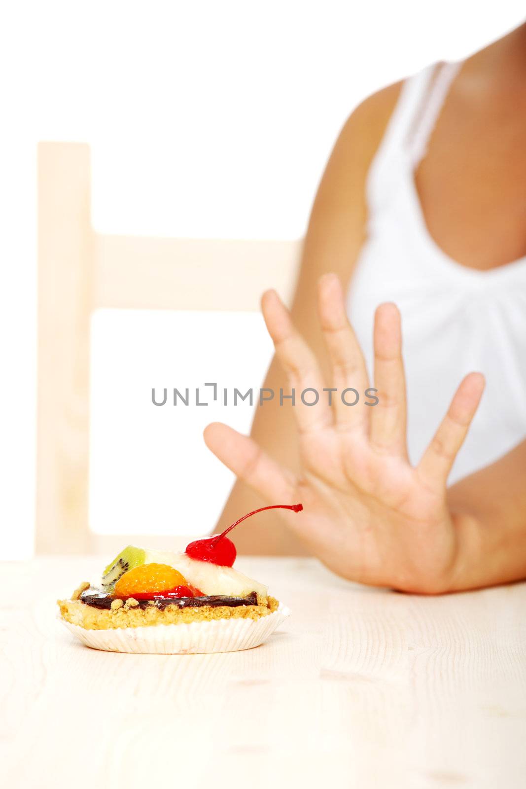 Hand showing stop gesture to cake. by BDS