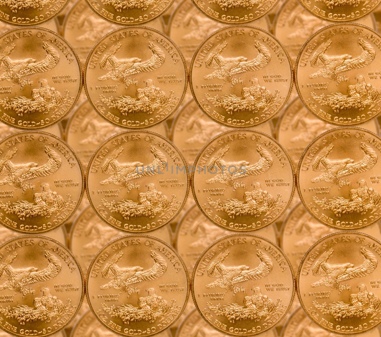 Gold Eagle one ounce coins in a patterns and stacked on each row