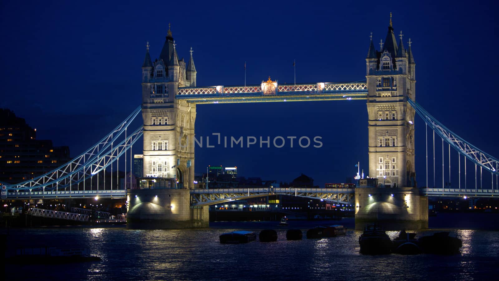 The tower bridge in London England at night. It was completed in 1894 and is a famous landmark for tourists and travel