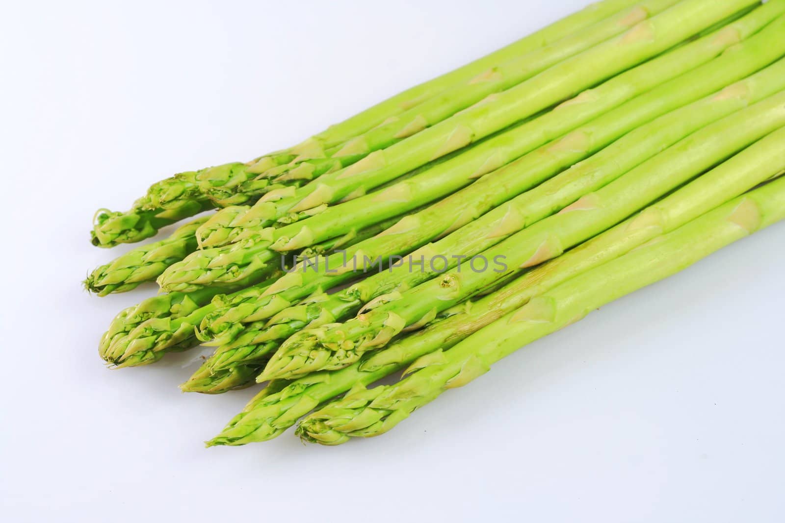 bunch of asparagus spears isolated in white background
