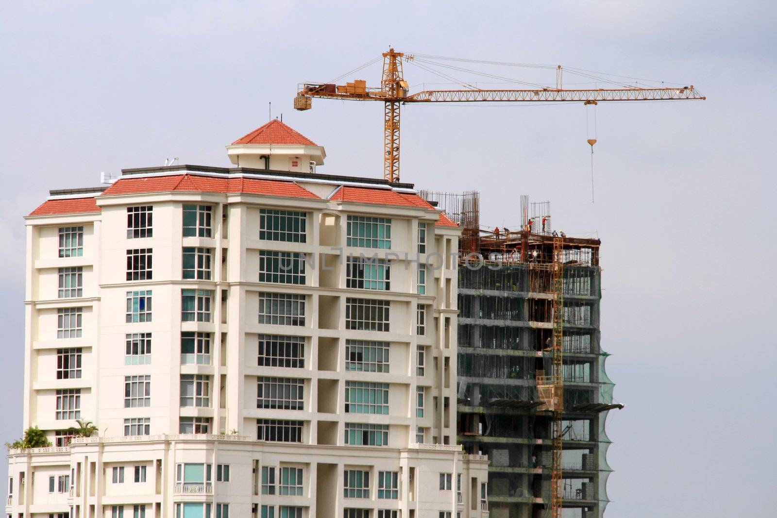 building construction site with industrial crane and workers
