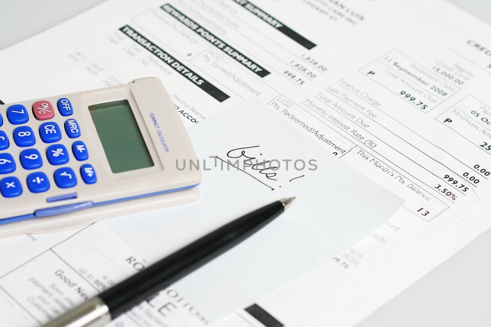 monthly billing statement with pen and calculator
