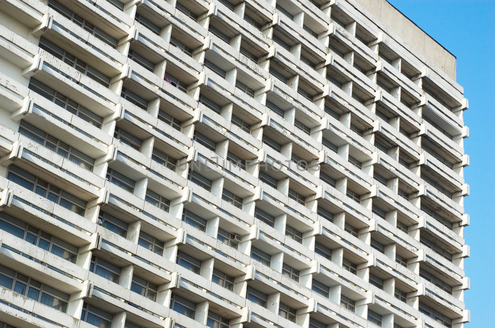 exterior of prematurely aged white hotel building