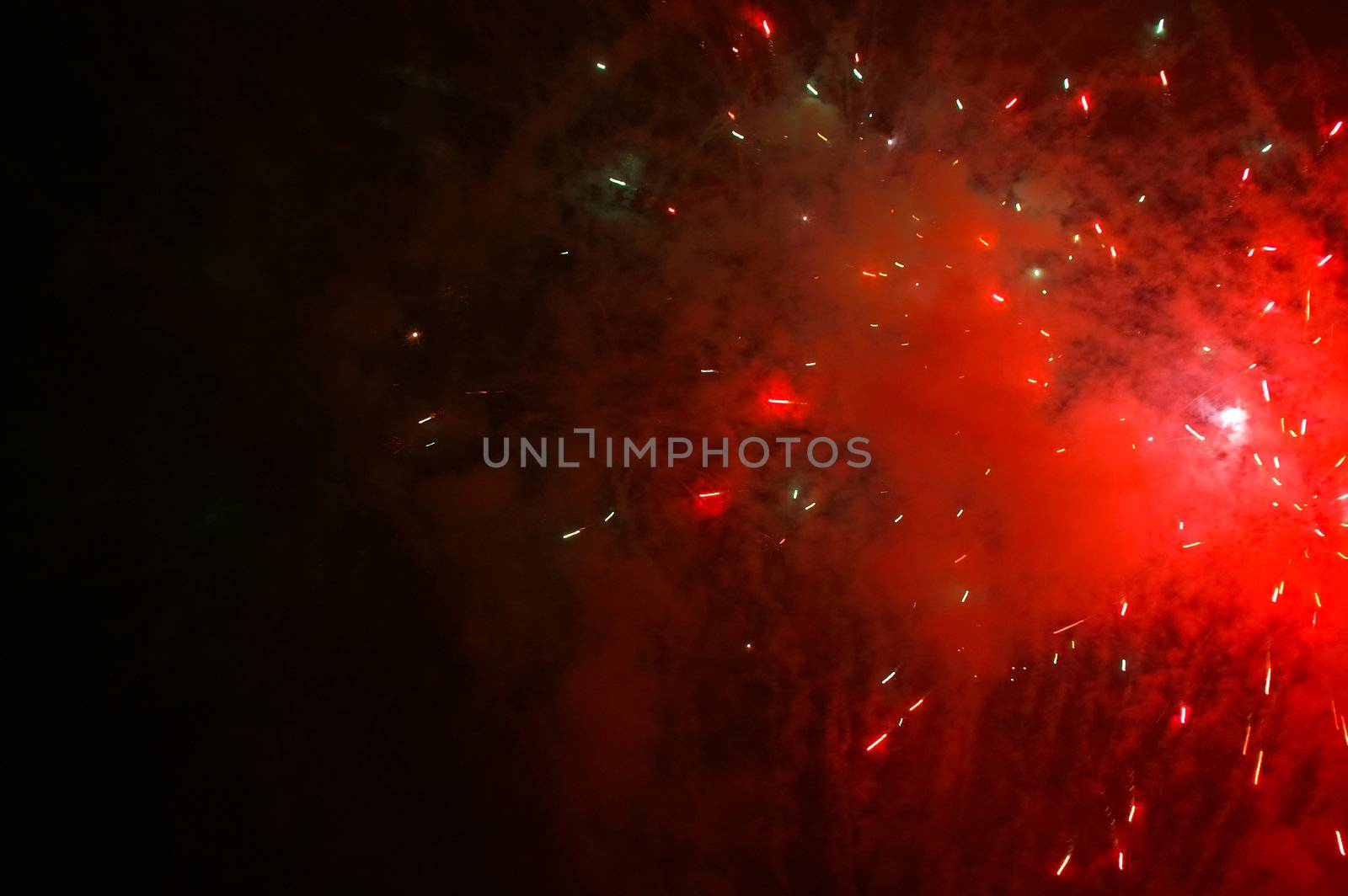 red exploding fireworks on a dark sky 
