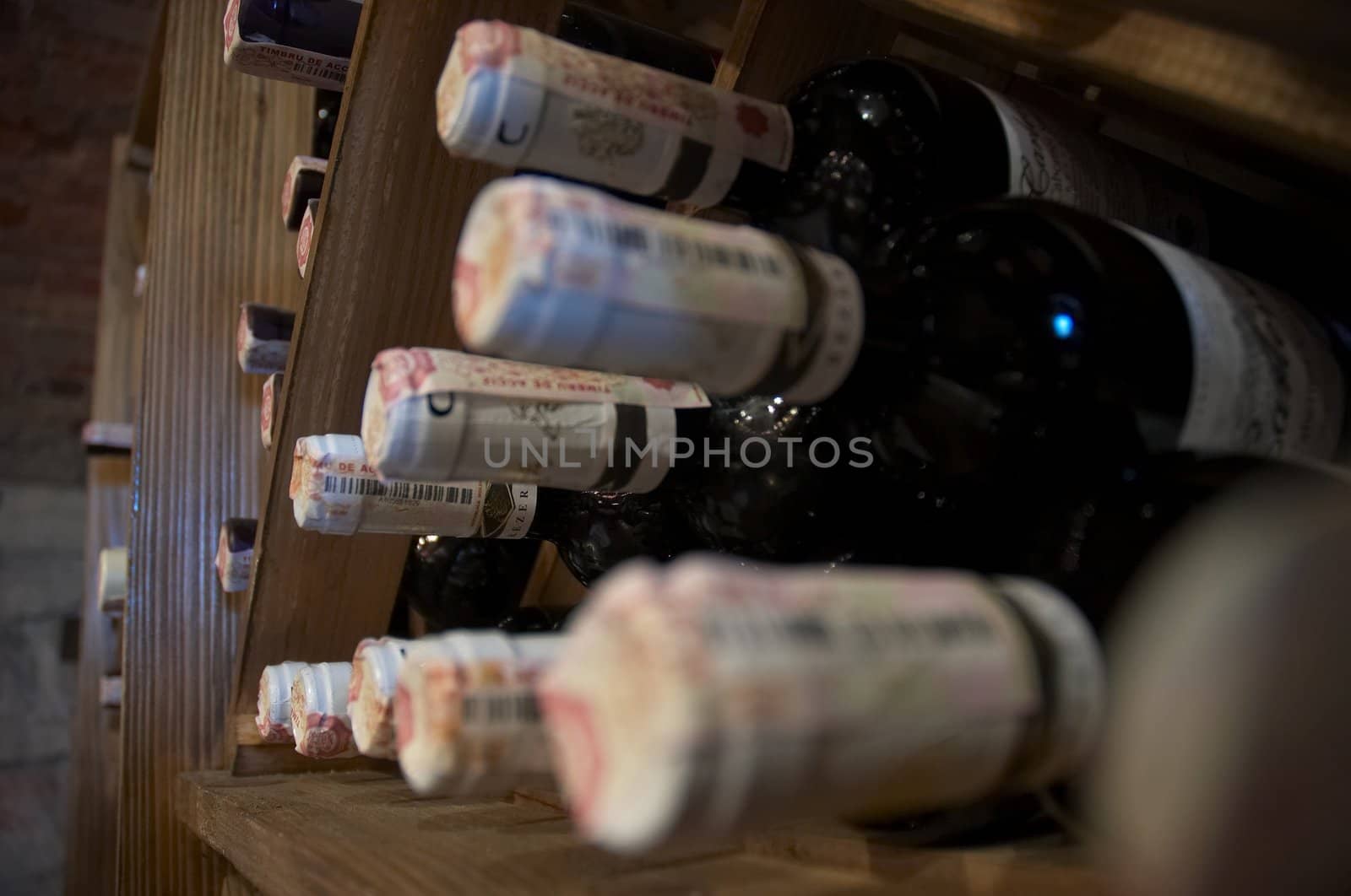 wine bottles laying in wooden rack