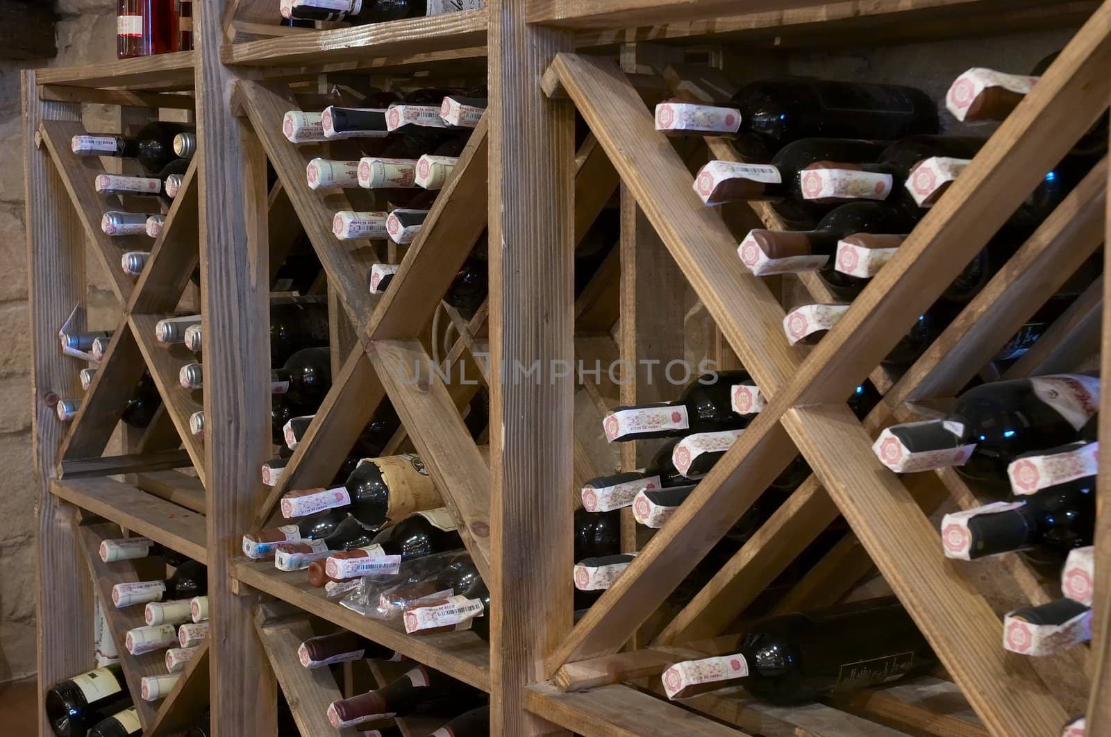 wine bottles laying in wooden rack