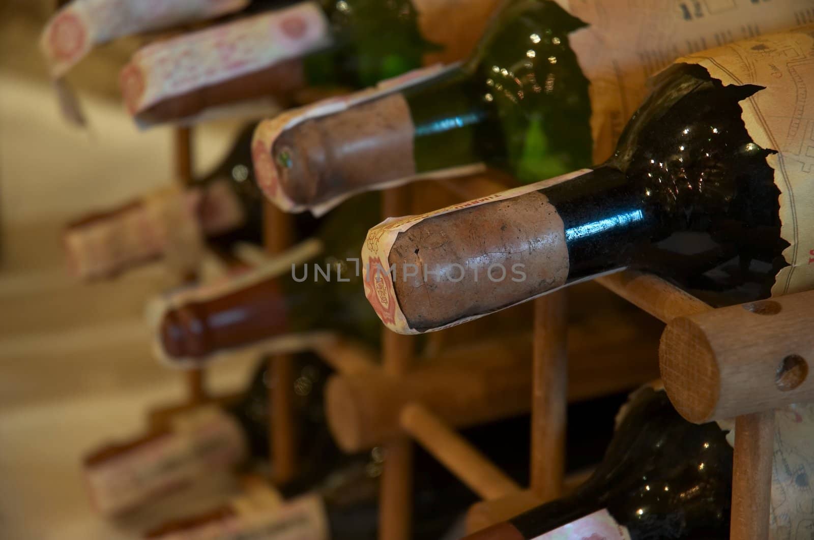 wine bottles laying in wooden rack