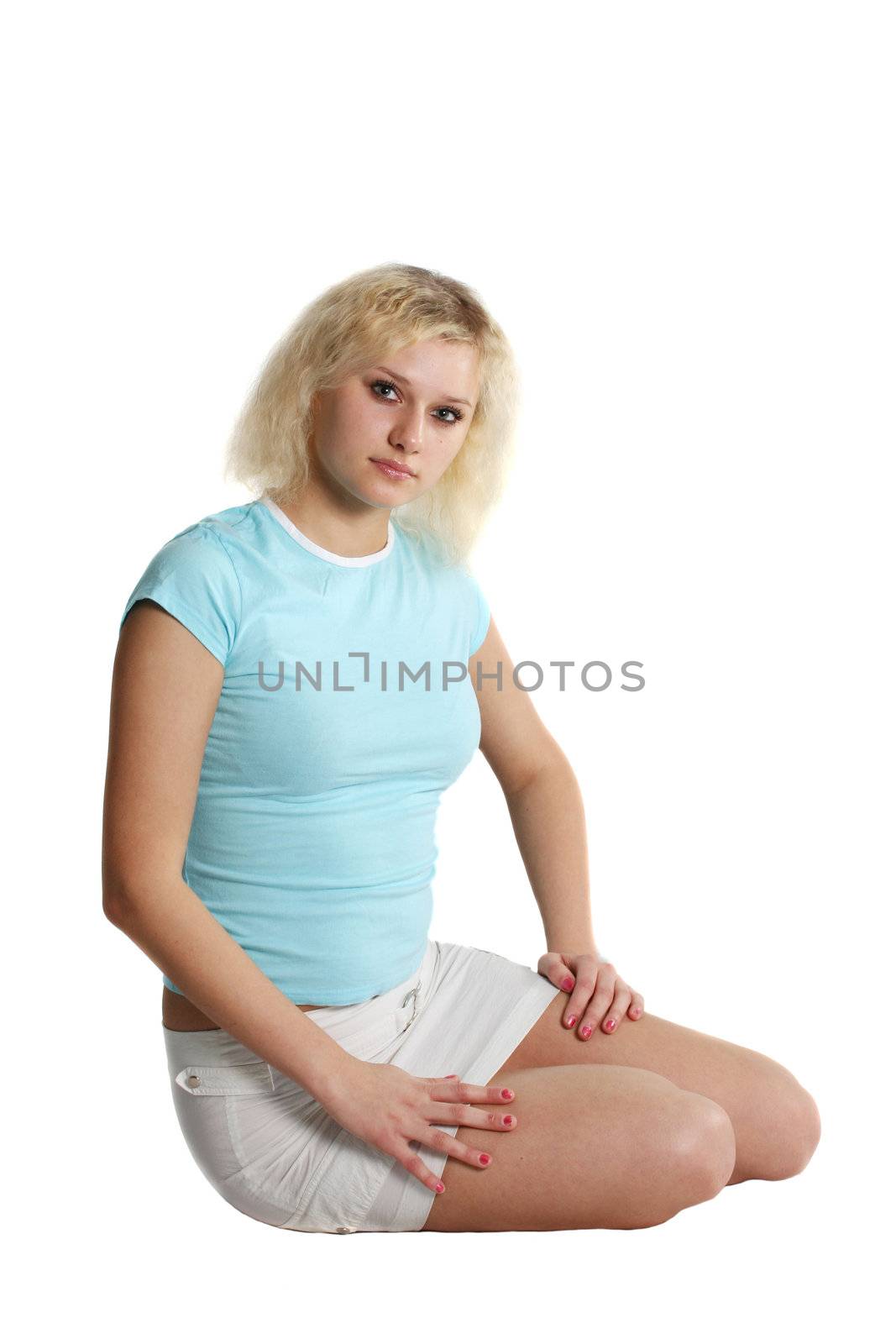 The blond girl poses in a short skirt 