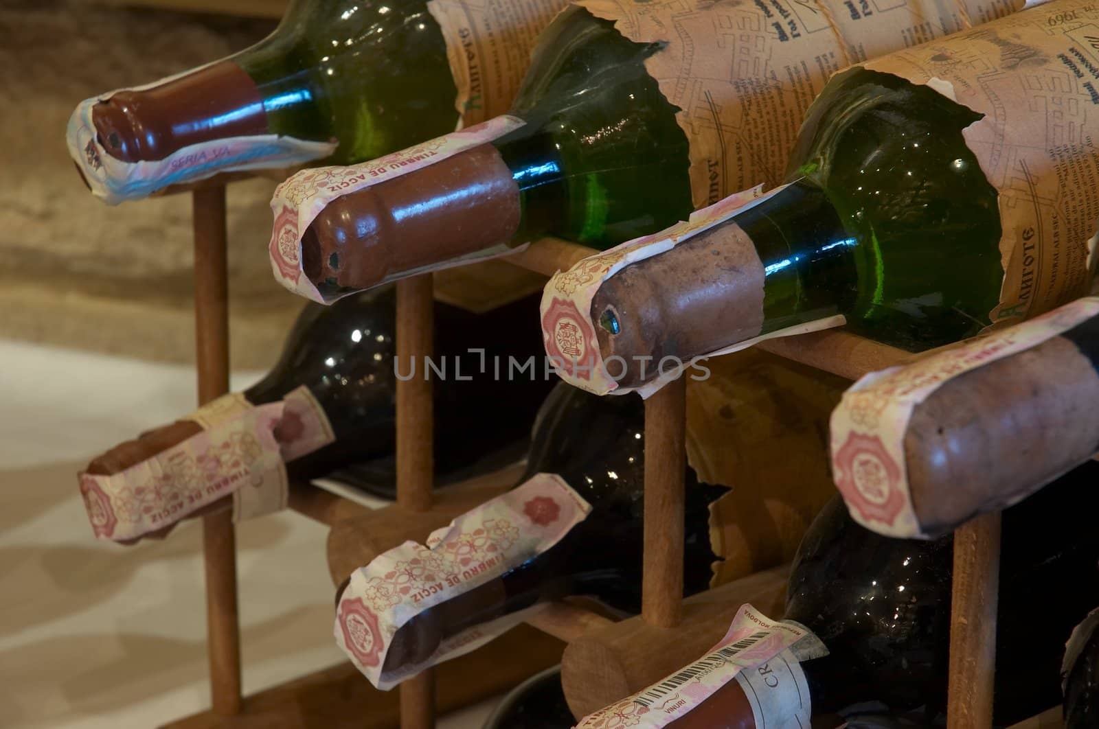 wine bottles laying in wooden rack