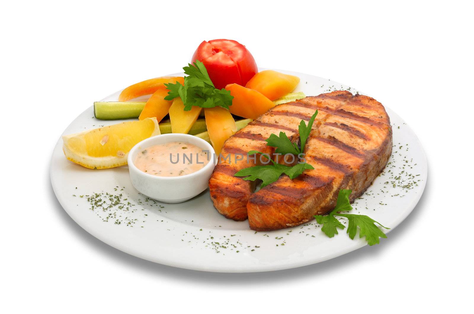 Grilled sturgeon fish with fresh vegetables. served  on the plate with yellow pepper, cucumber and tomato
