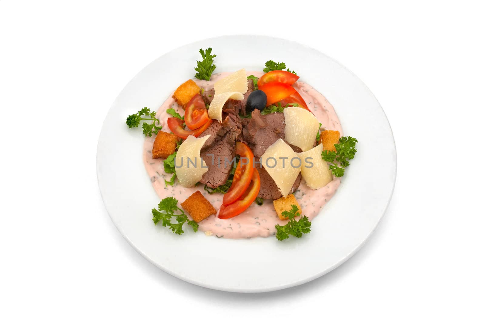 Veal salad with sliced fresh tomato, parmesan chips and cracker pieces, dressed with rose sauce and parsley