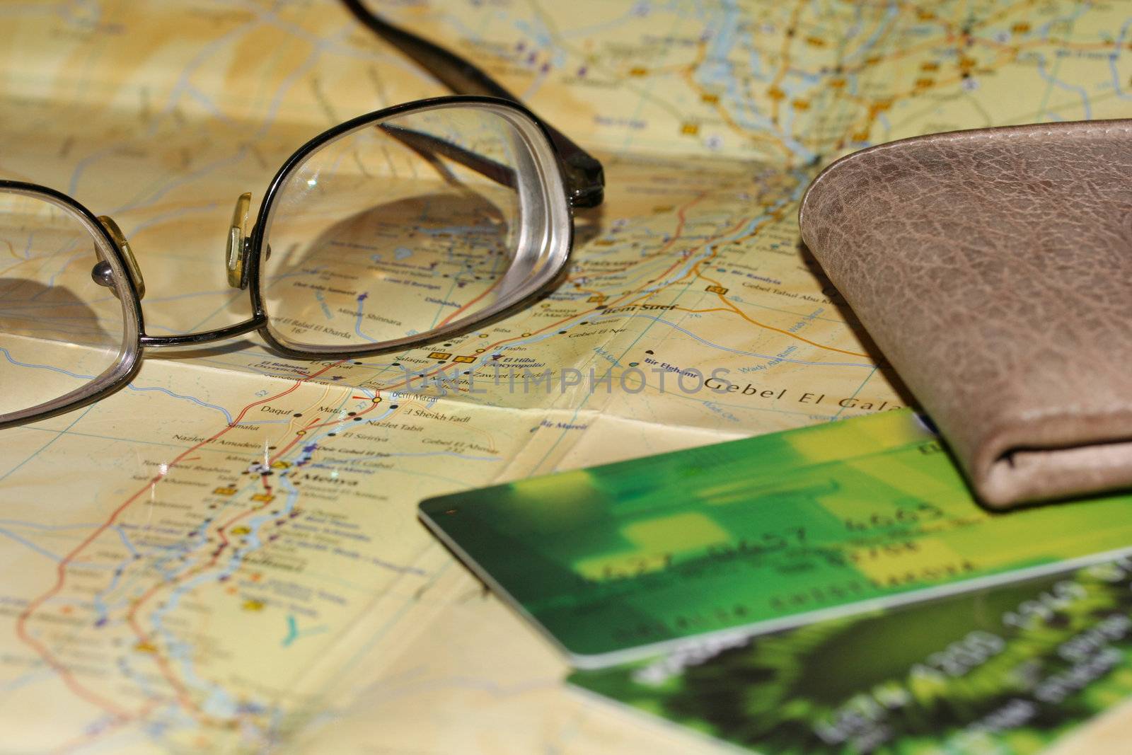Purse, credit cards and glasses on a tourist map