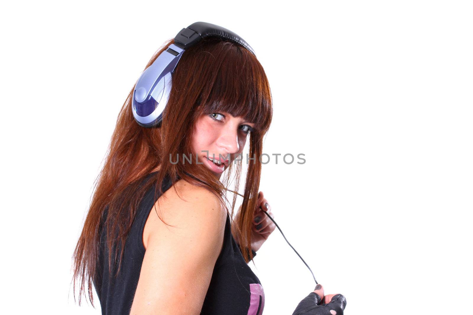 The young girl in headphones with a microphone listens to music