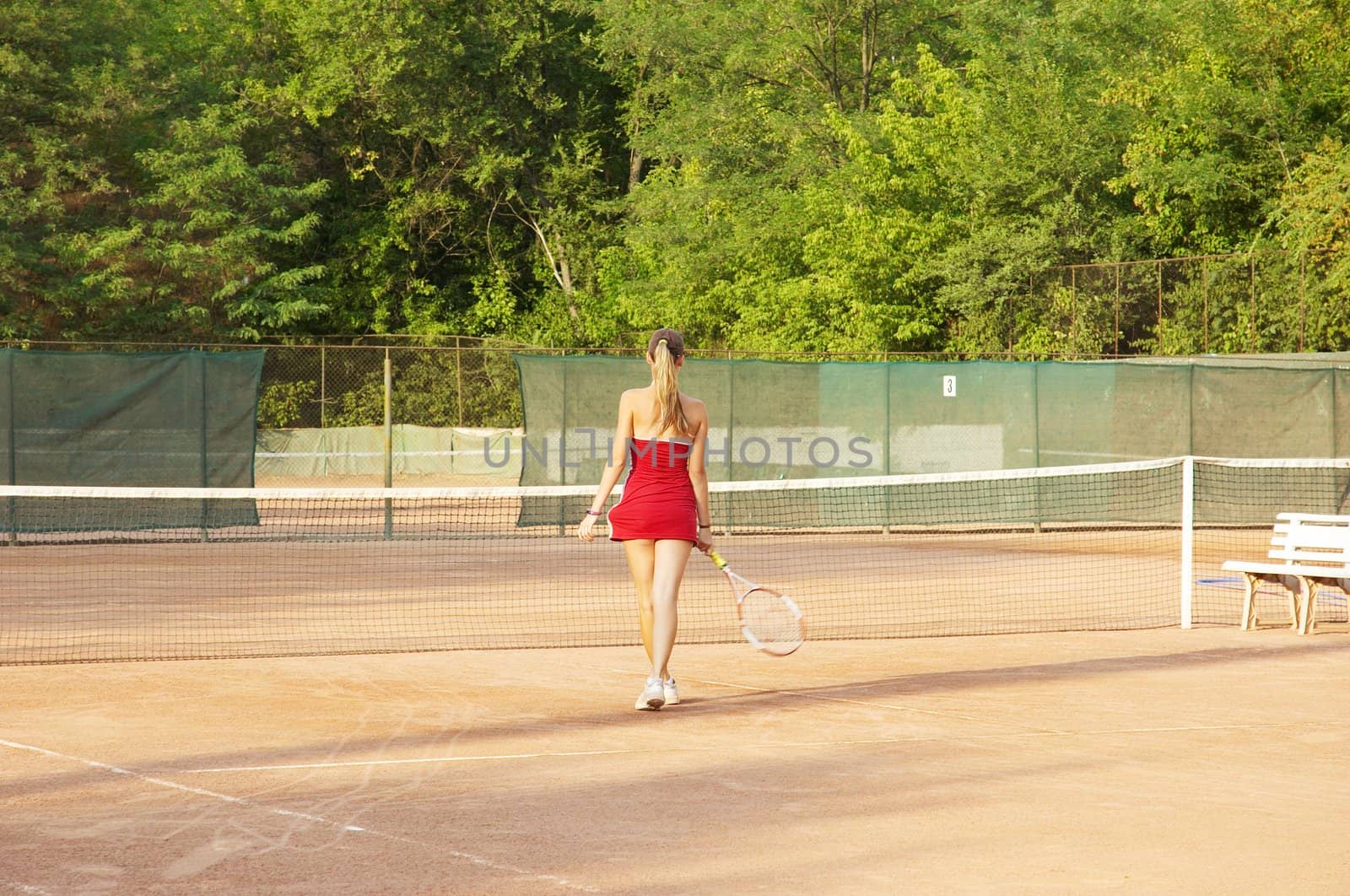 blond girl on the tennis court, rear view