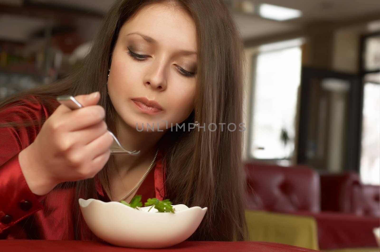 Beautiful brunette eats salad. by starush