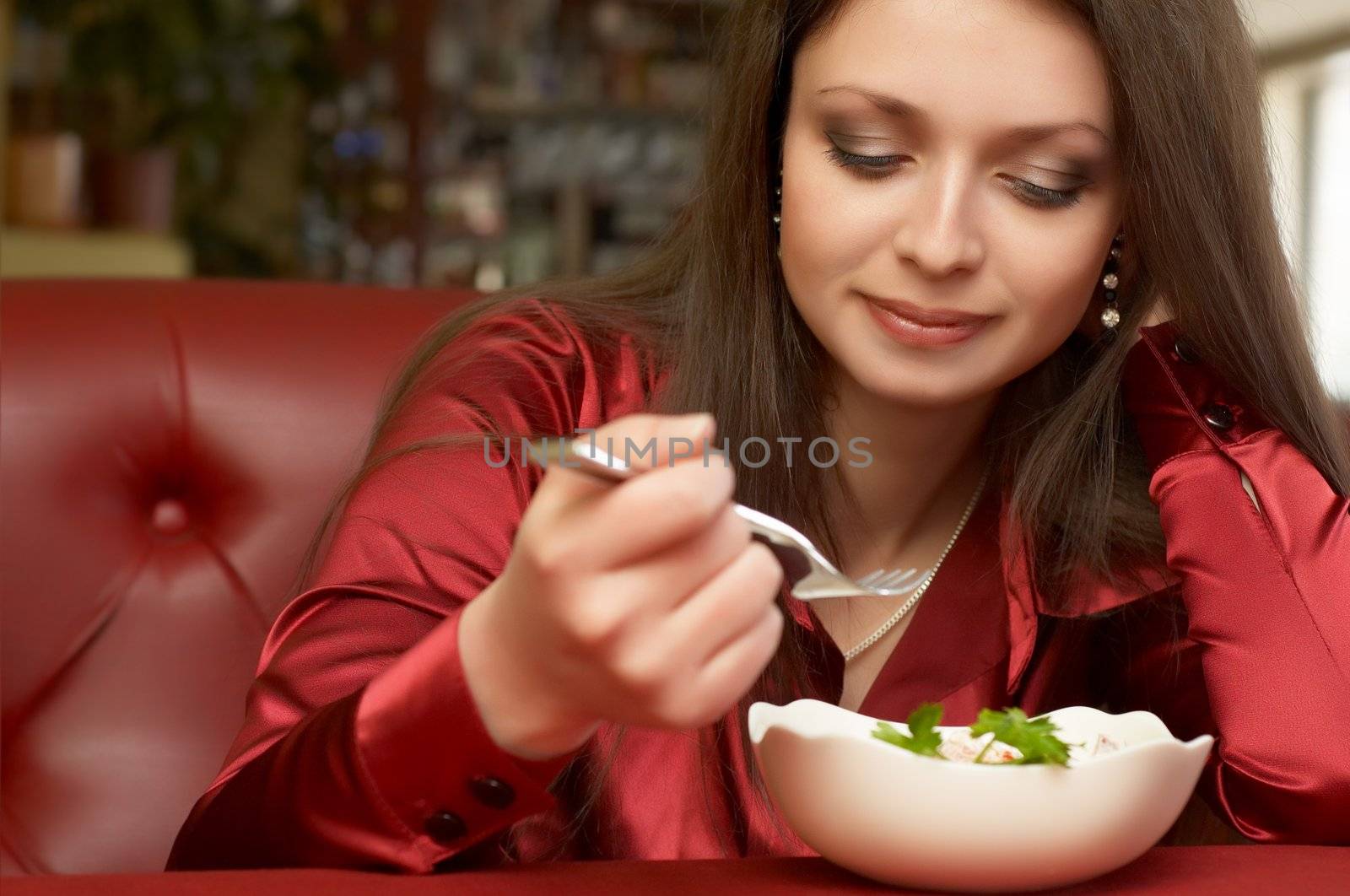 Beautiful brunette girl eats salad. by starush