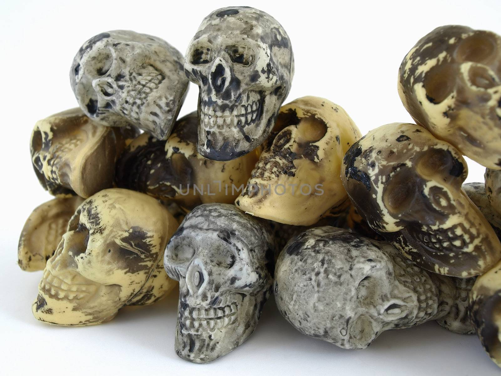 A pile of plastic toy skulls studio isolated over a white background.