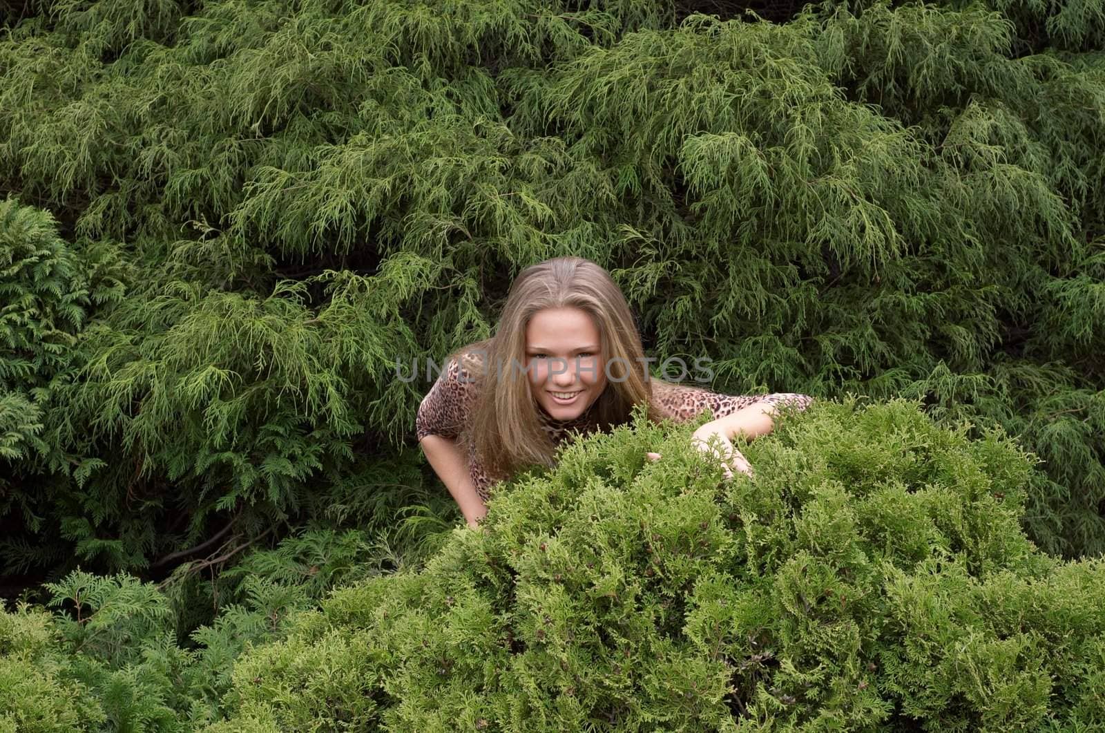 Cute girl hiding in bushes by starush