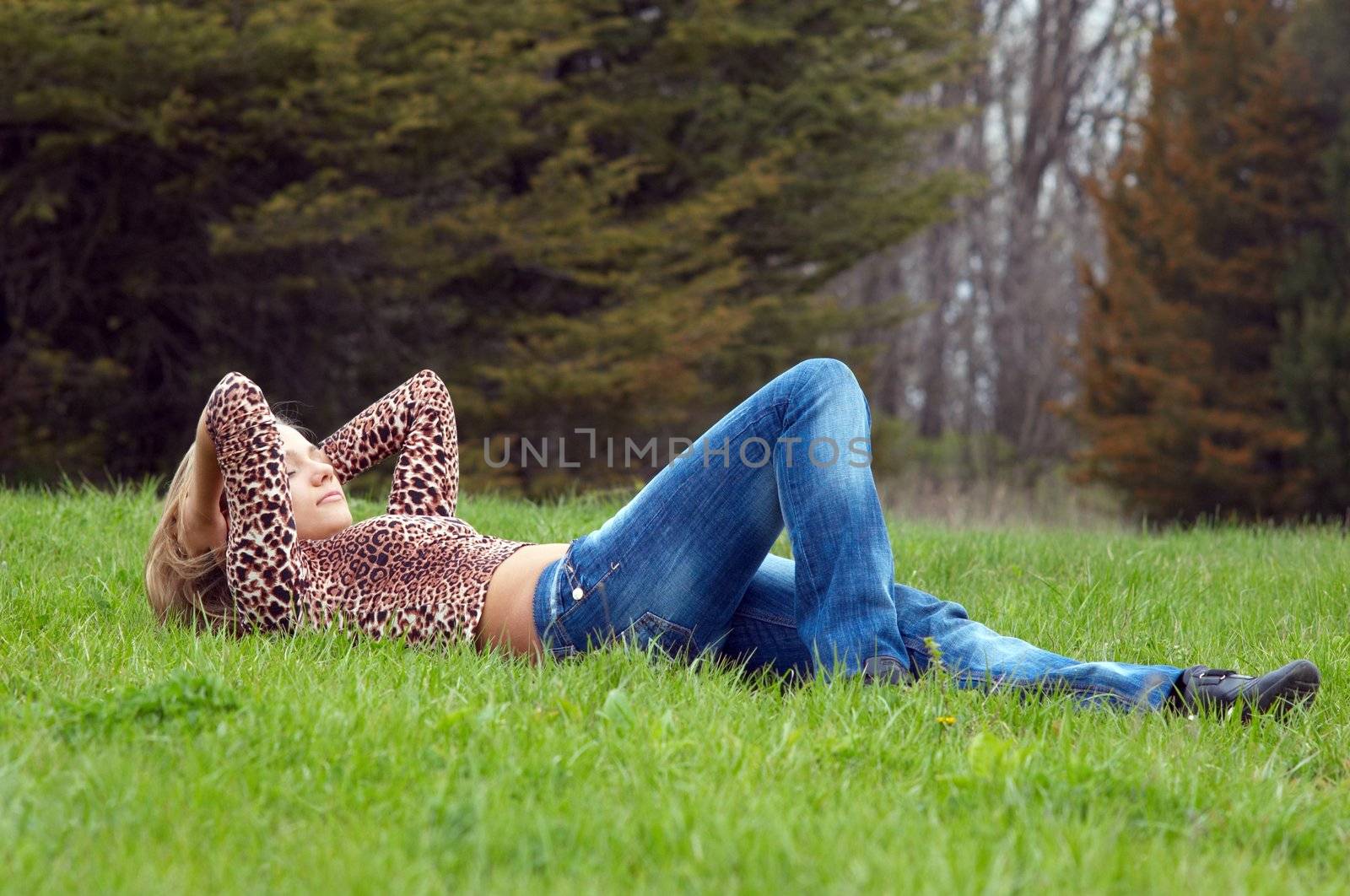 cheerful girl laying on the green grass.