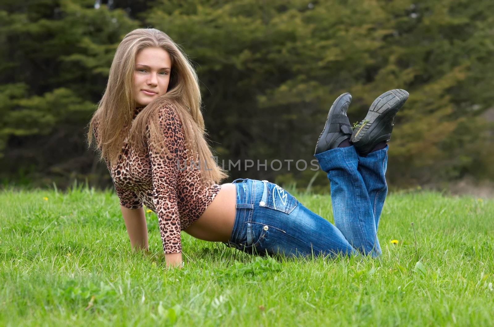 cheerful girl laying on the grass by starush