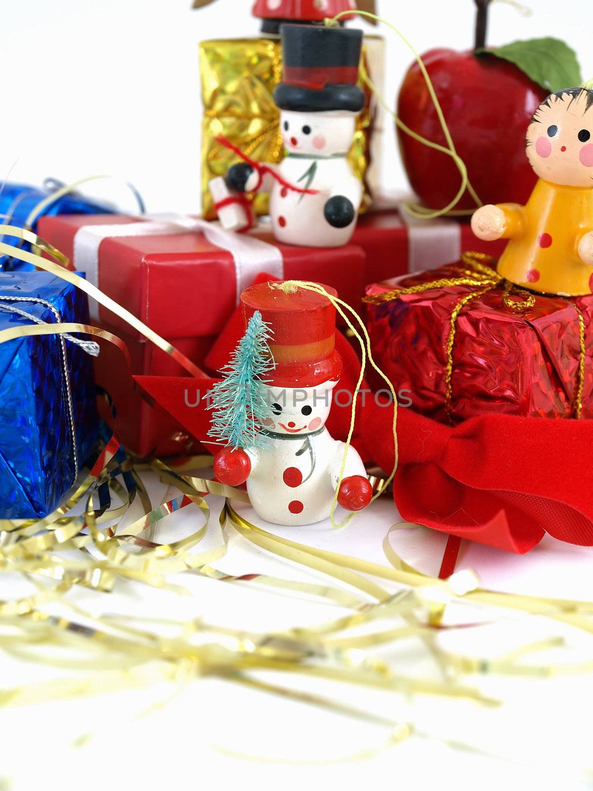 Cute colorful wooden Christmas tree ornaments, displayed with colorful wrapped presents. Over white.