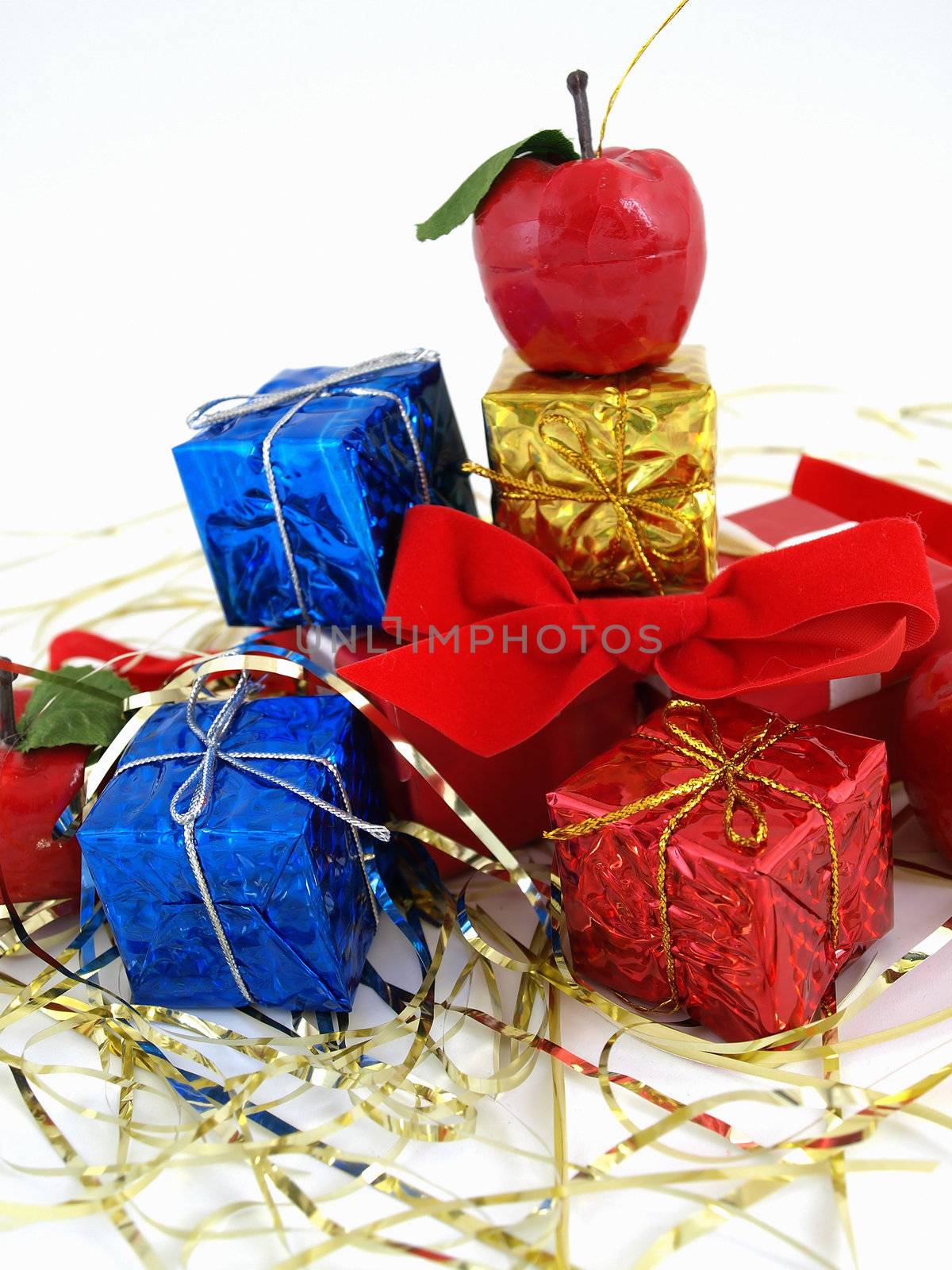 Colorful gift boxes and tinsel studio isolated against a white background.