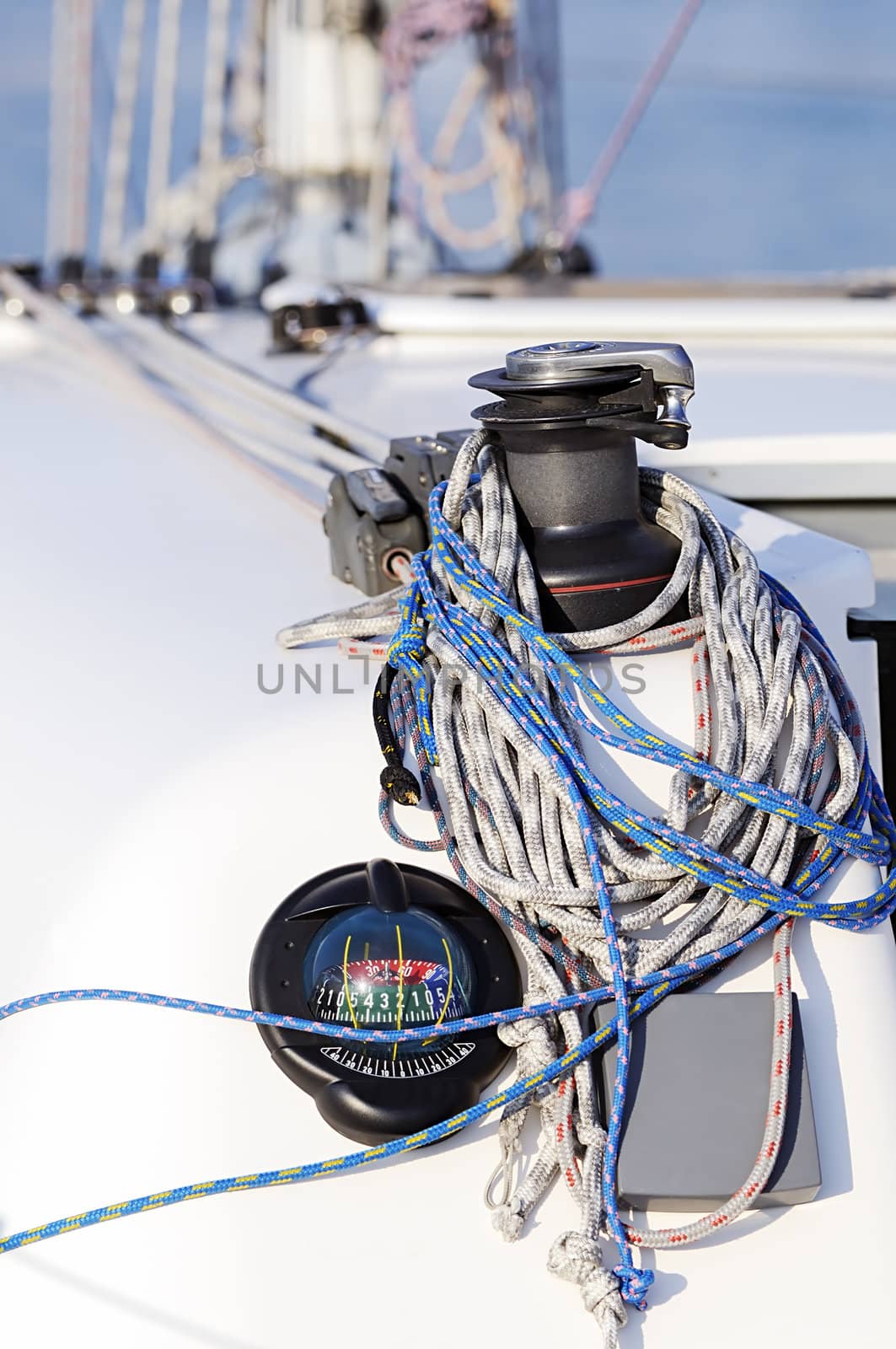 Detail of a sailboat: compass, winch and rigging