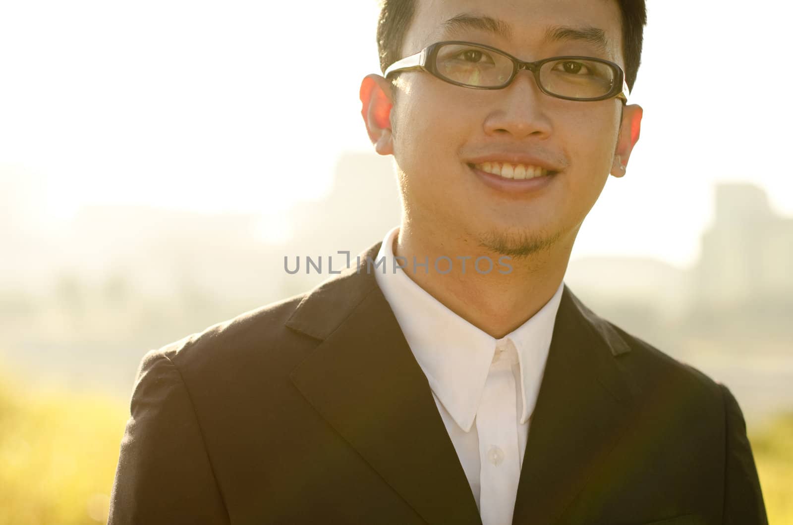 Asian groom at outdoor in a morning surrounding by golden sunlight