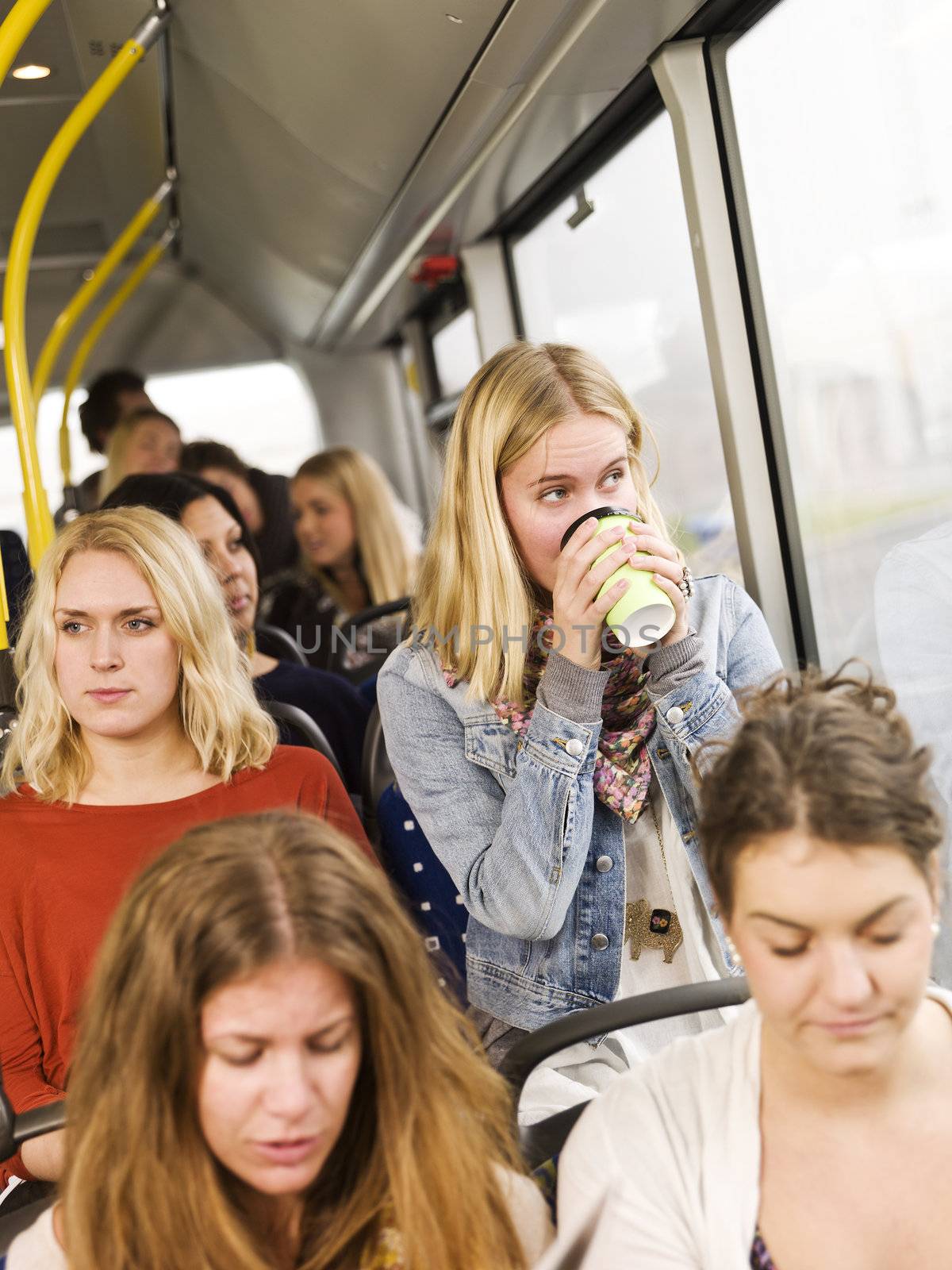 Woman drinking coffee on the bus