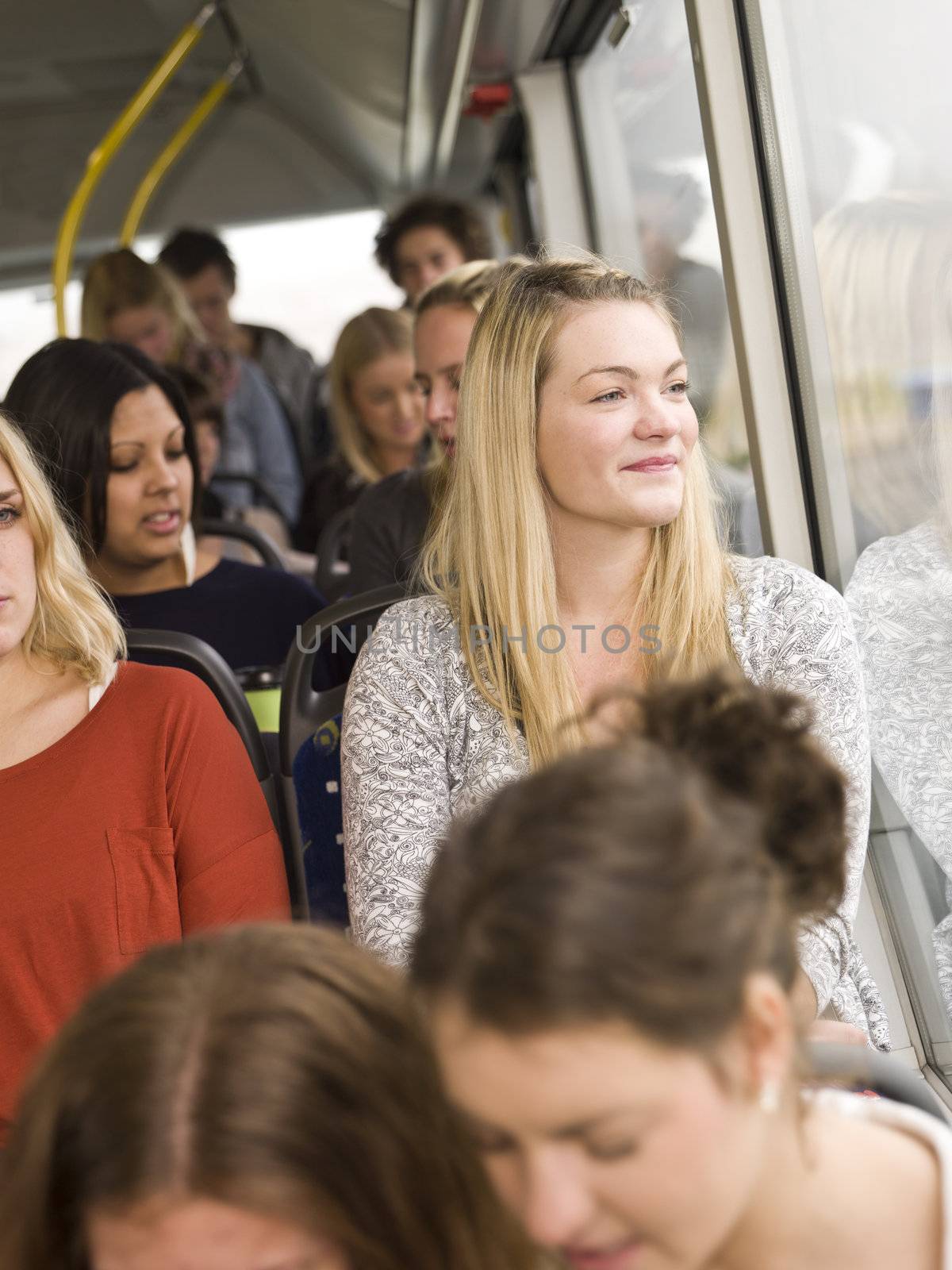Happy woman at the window on a bus