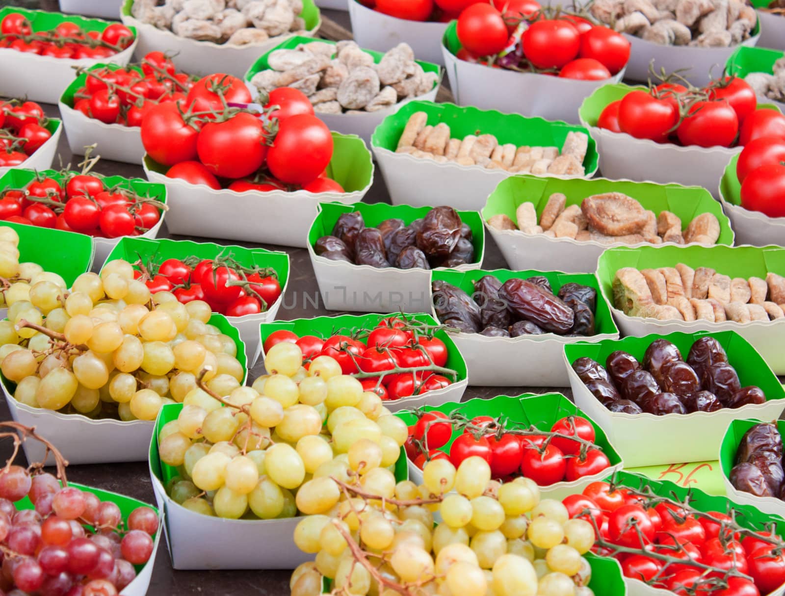 Display in a french market, bunch of grapes, cherry tomatoes