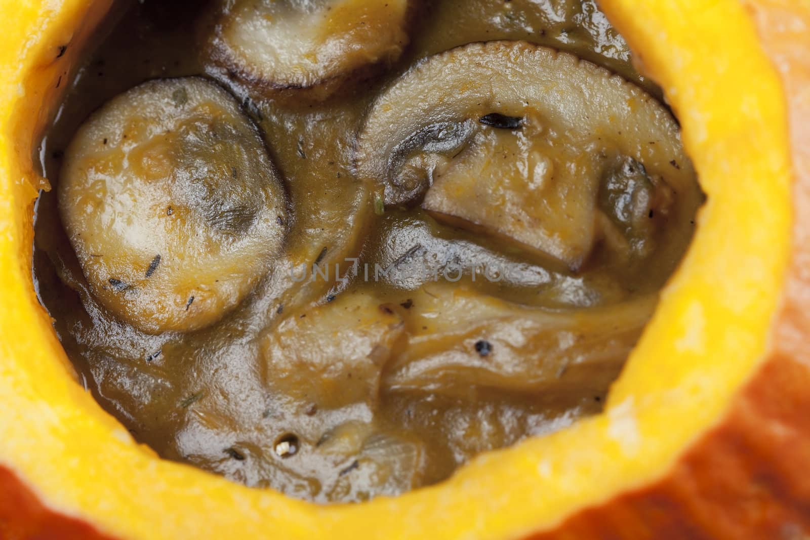 Creamy mushroom and pumpkin soup in a pumpkin bowl.