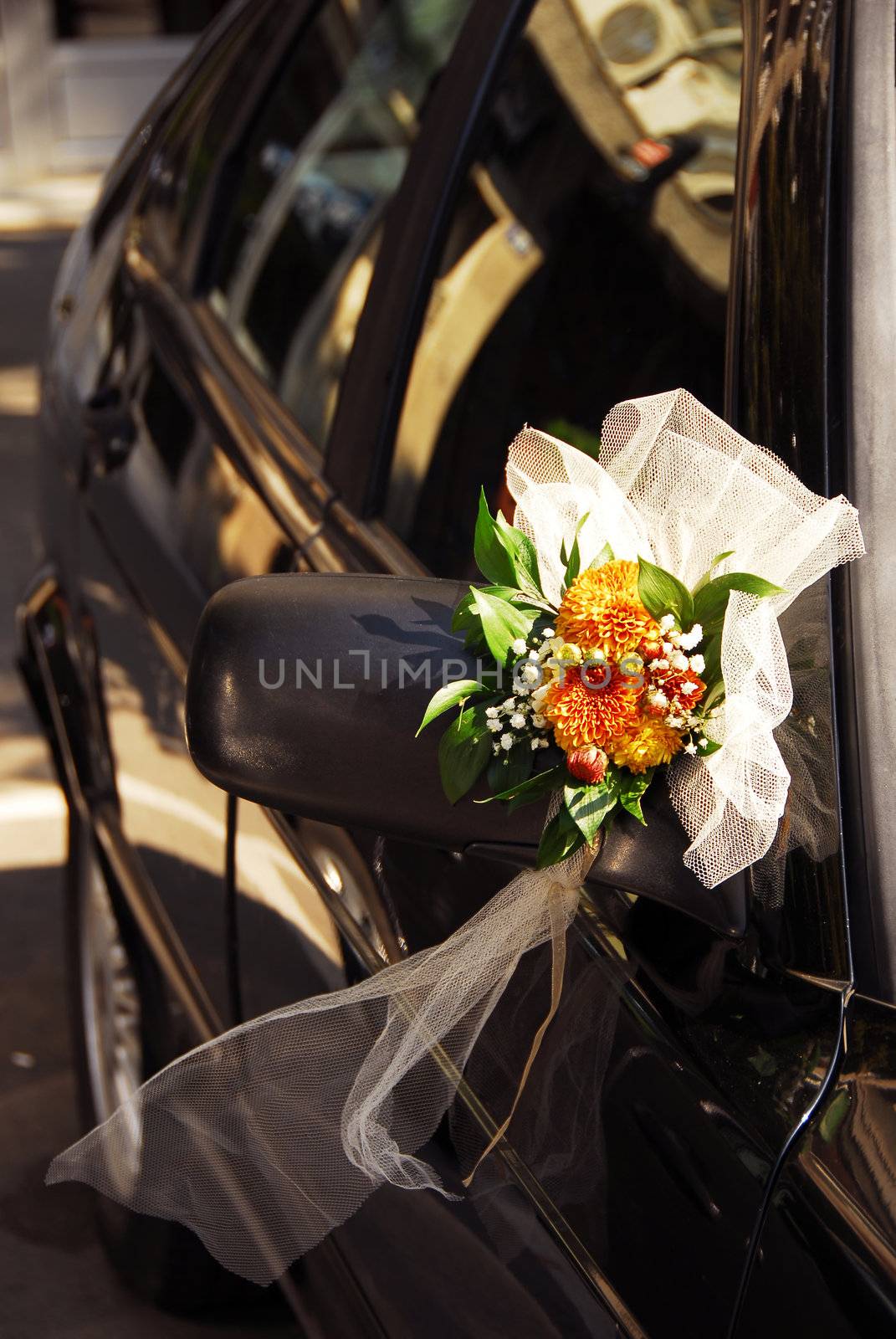 wedding flowers decoration on black car mirror