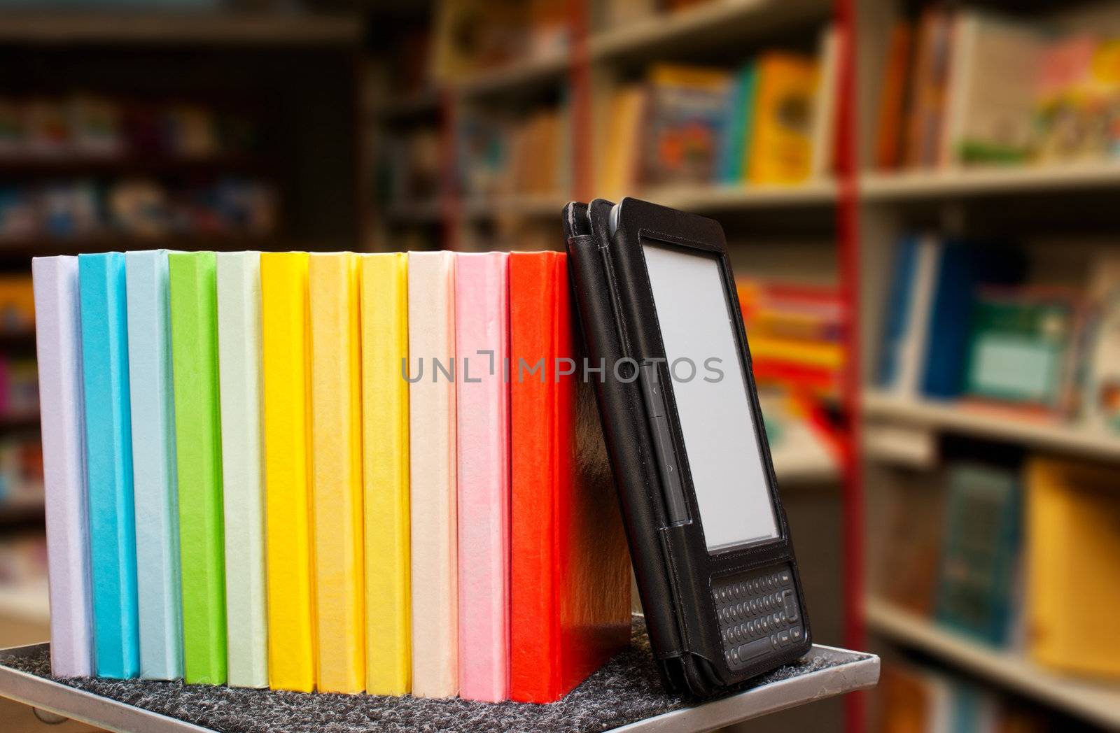 Row of colorful books with electronic book reader