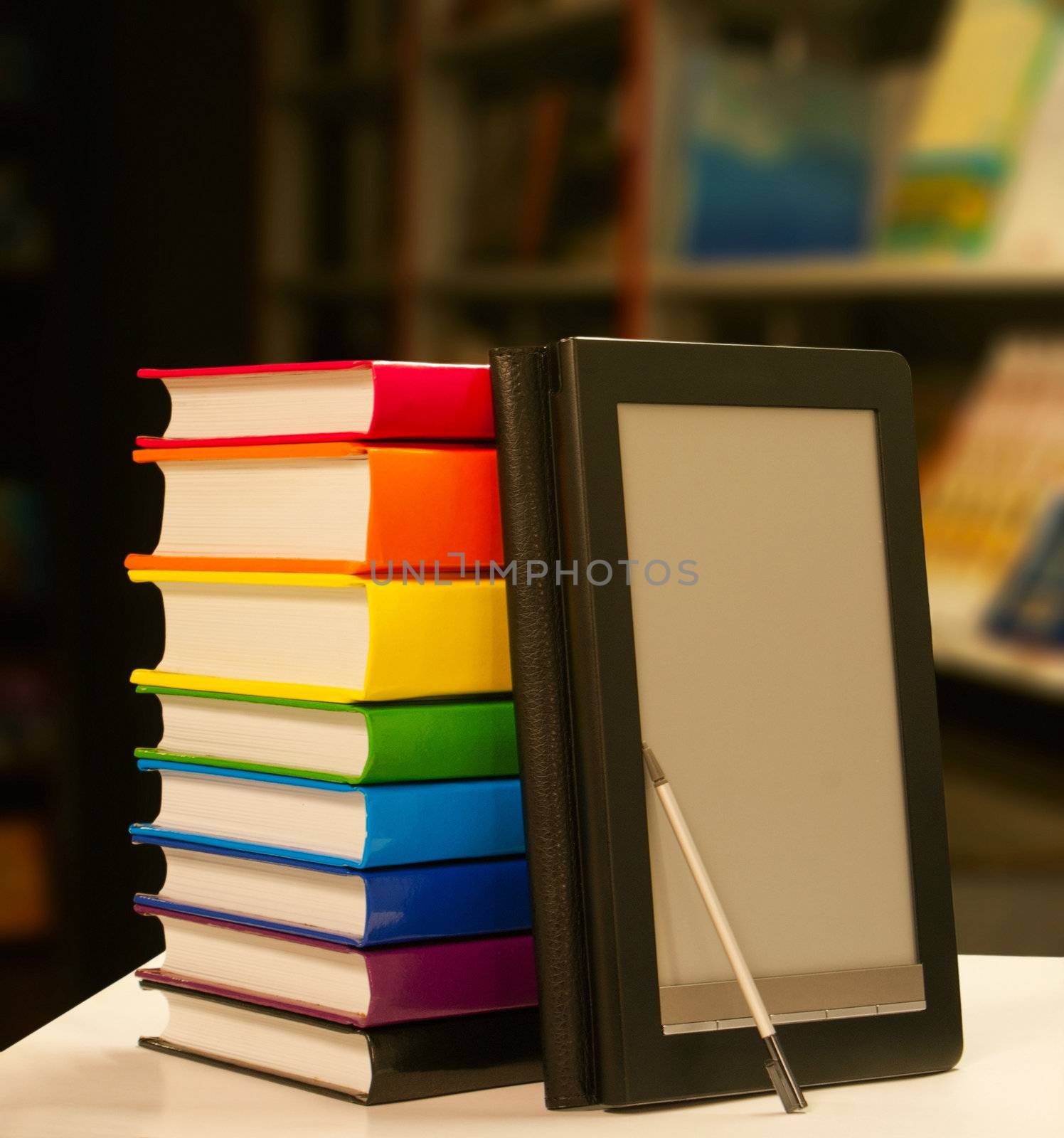 Stack of books with electronic book reader by AndreyKr
