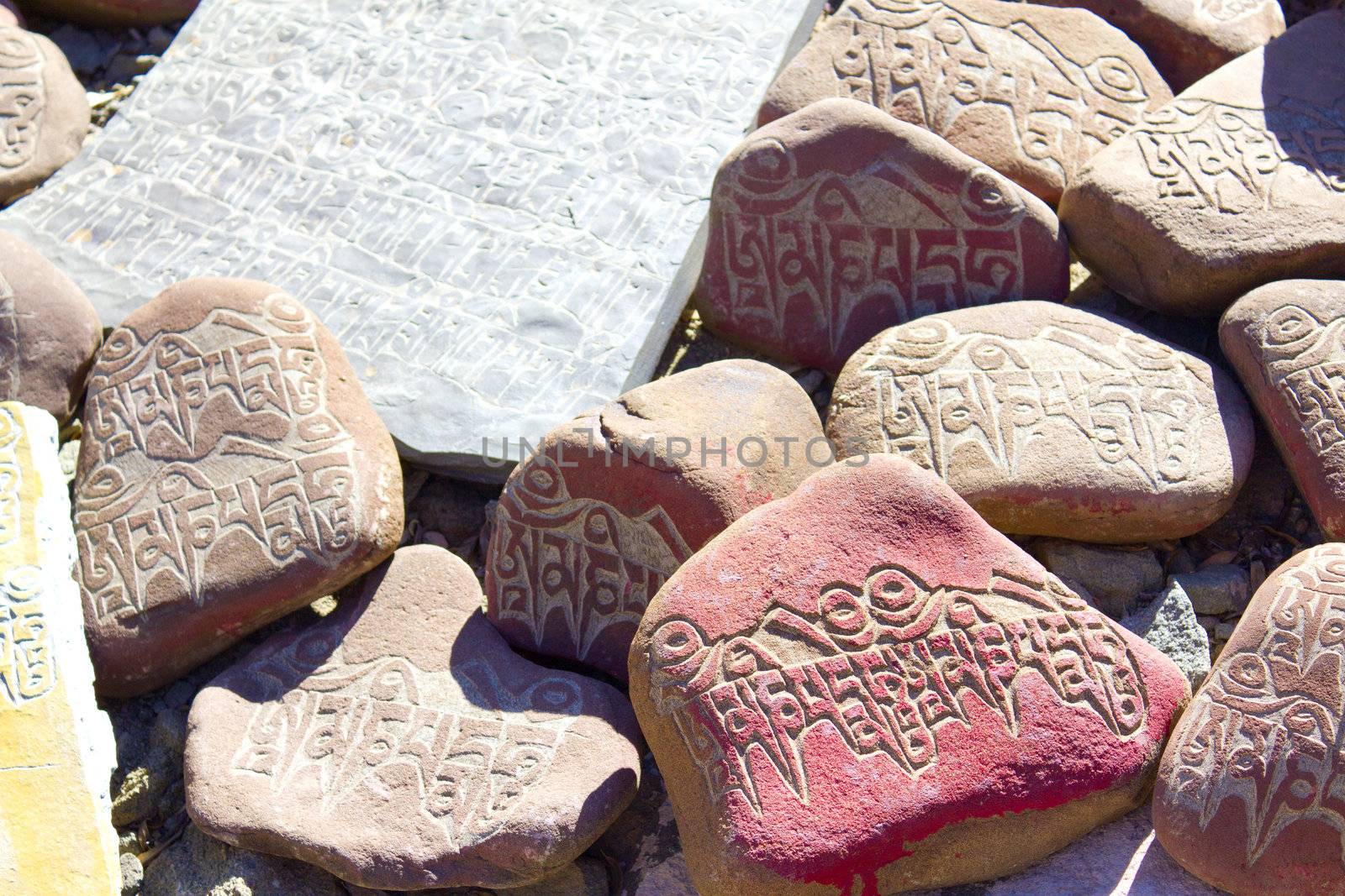 stones in the mountains with written on them Buddhist mantras