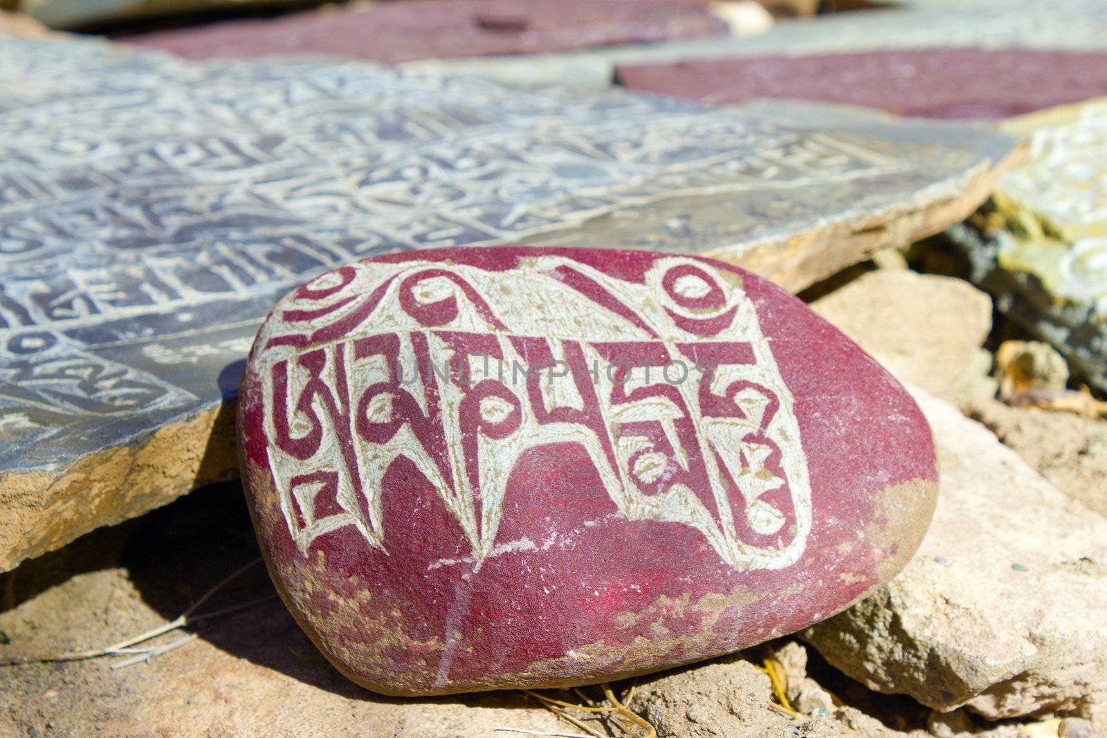 stones in the mountains with written on them Buddhist mantras