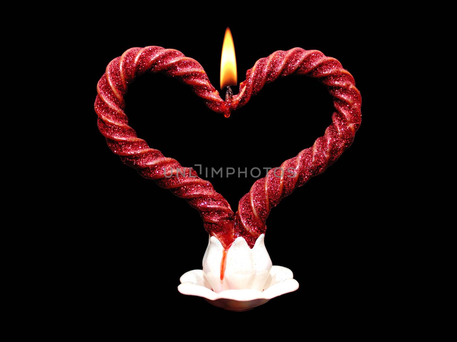 Two red burning candles in the form of heart