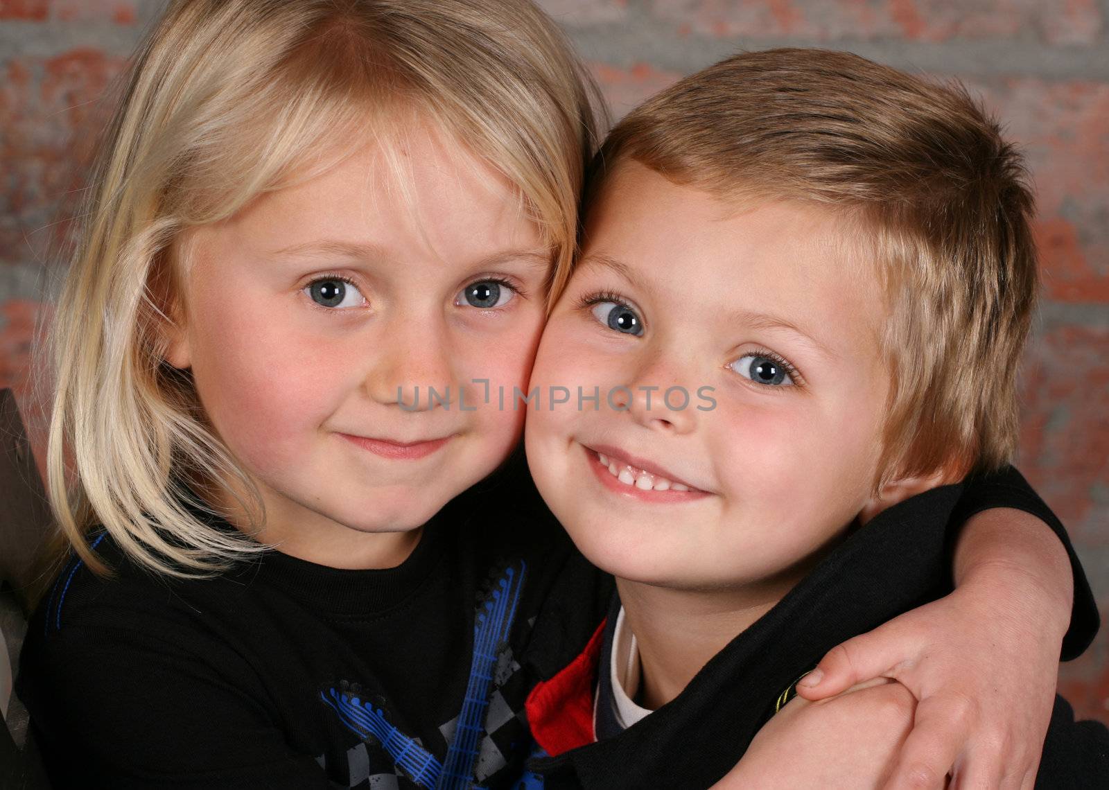 Beautiful young girl with blond hair and her cute boy friend 
